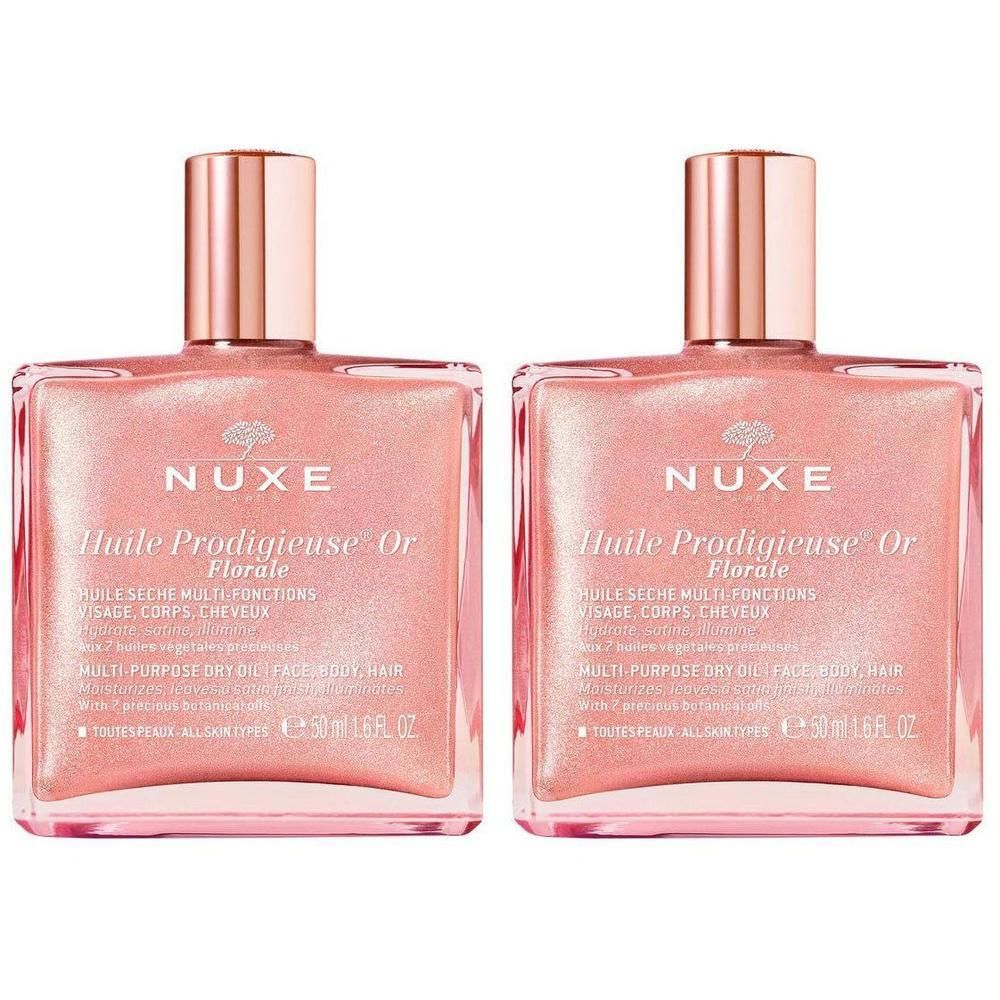 Deux flacons carrés d'huile rose et bouchon doré. Inscription: Nuxe Huile Prodigieuse Or Florale.