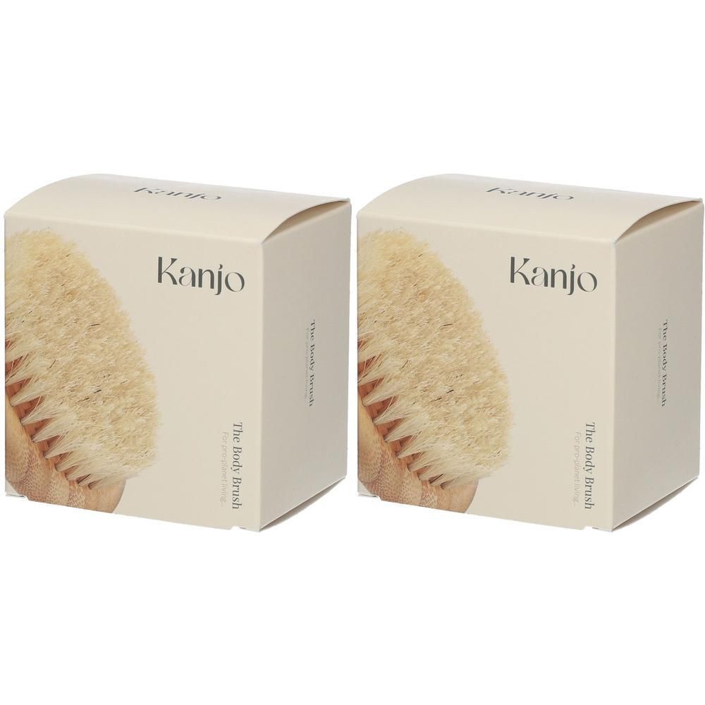 Deux boîtes carrées. Sur le devant, une partie d'une brosse pour le corps est représentée. Le mot "Kanjo" est visible.