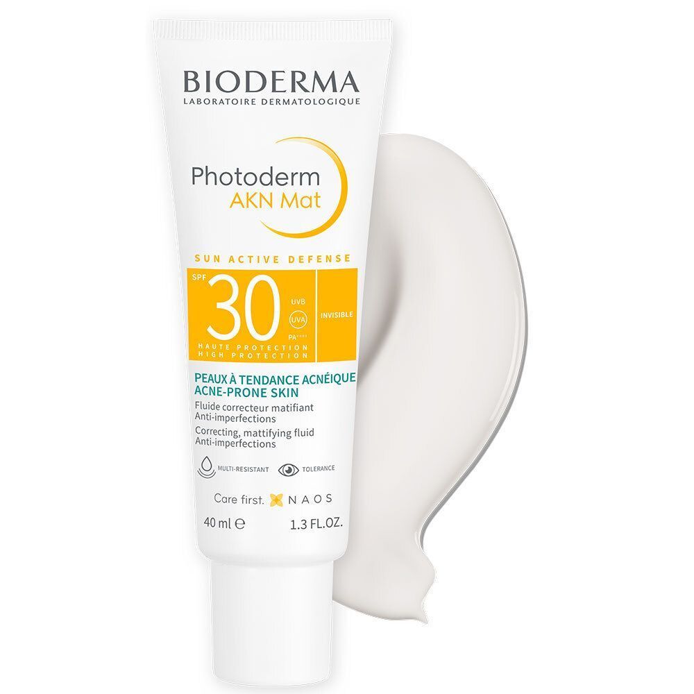 Tube BIODERMA Photoderm AKN Mat SPF30 et échantillon de produit. Tube blanc avec accents jaunes et une trace du produit.