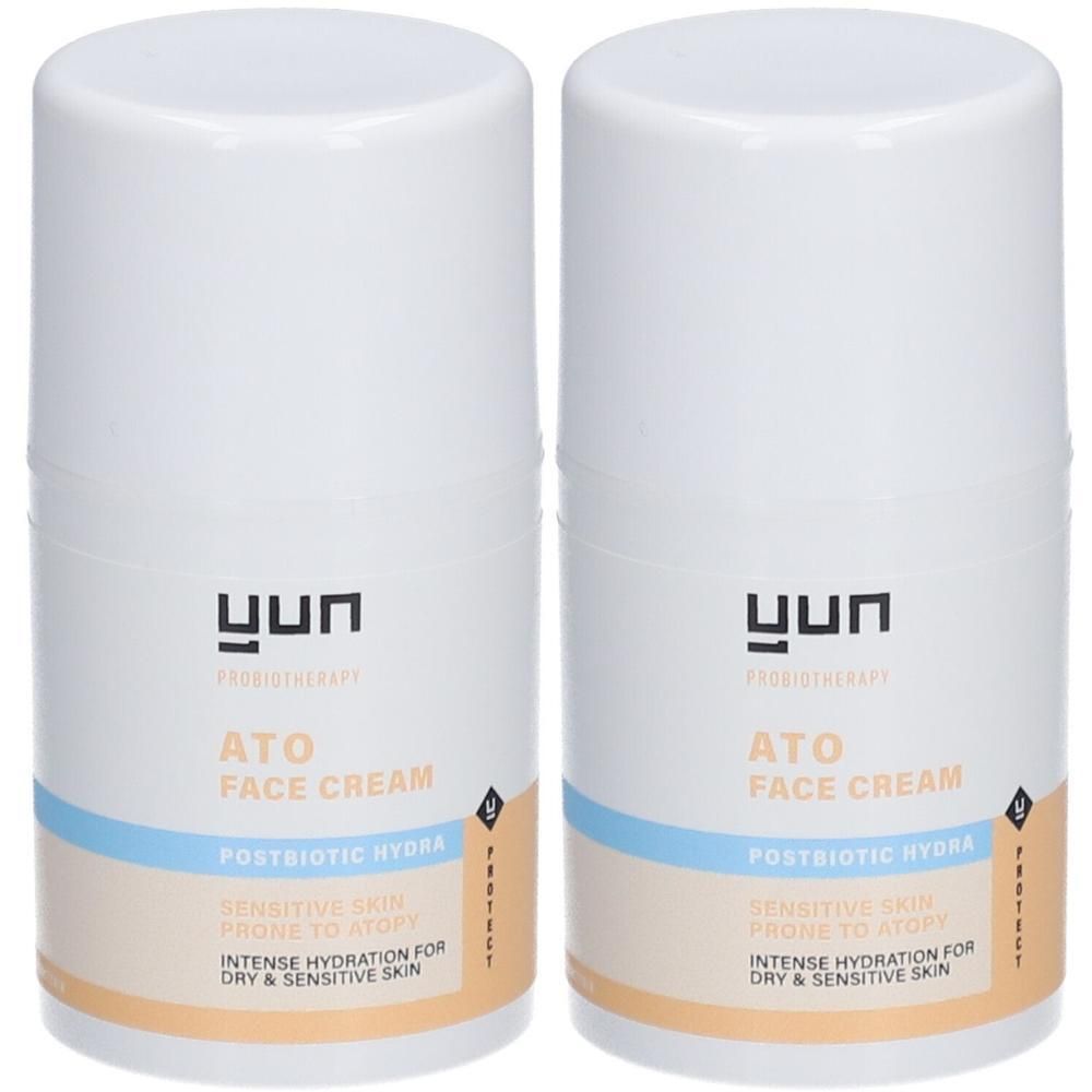 Deux pots de crème blancs avec étiquettes bleues et beiges. Inscription : ATO FACE CREAM, Postbiotic Hydra. Pour peaux sèches et sensibles.