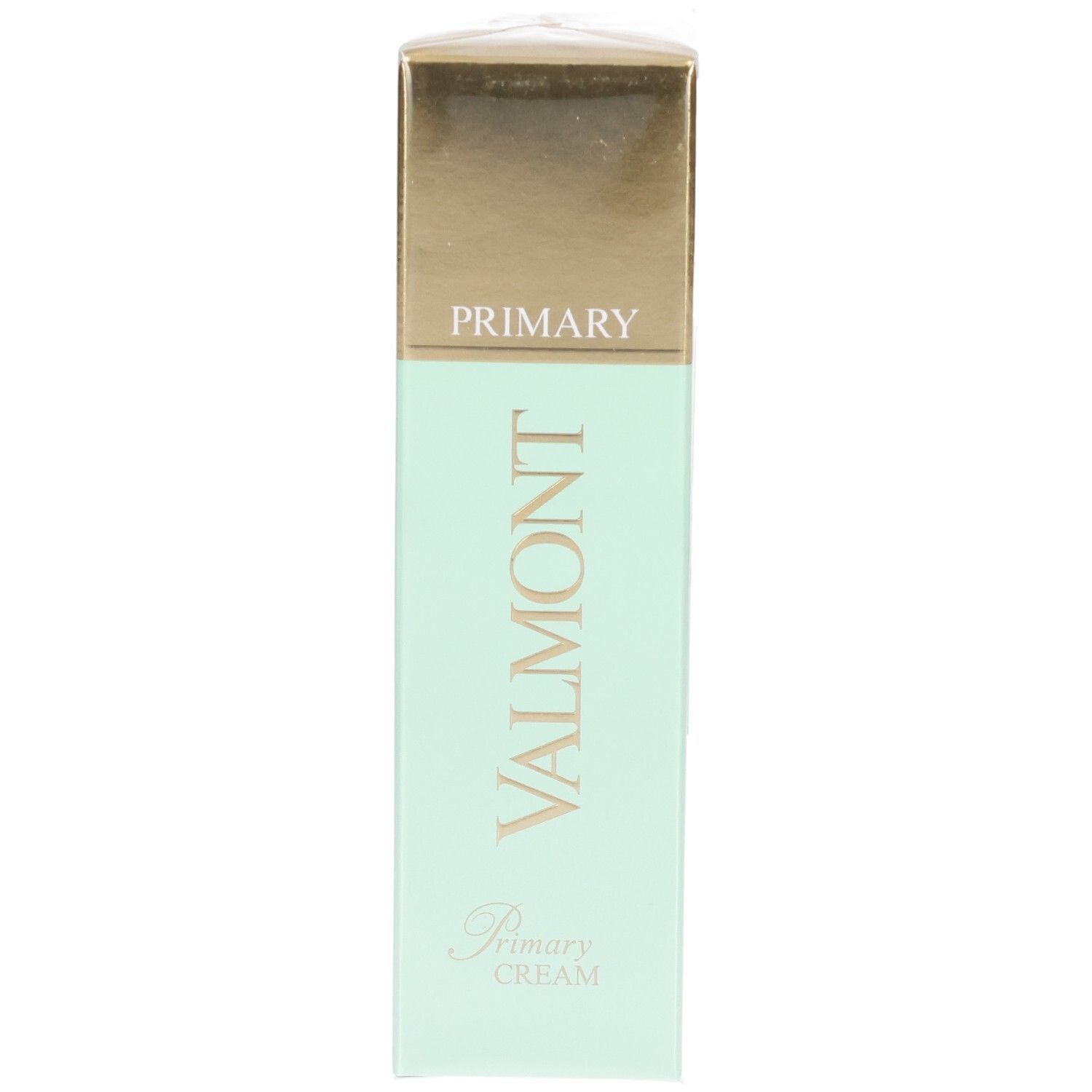 Emballage VALMONT Primary Cream, vert menthe avec capuchon doré et logo.