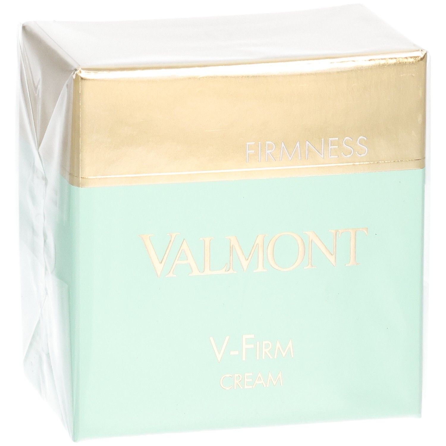 Emballage Valmont V-Firm Cream avec bandeau doré et menthe. "FIRM NESS" et "VALMONT" sont imprimés sur le devant.
