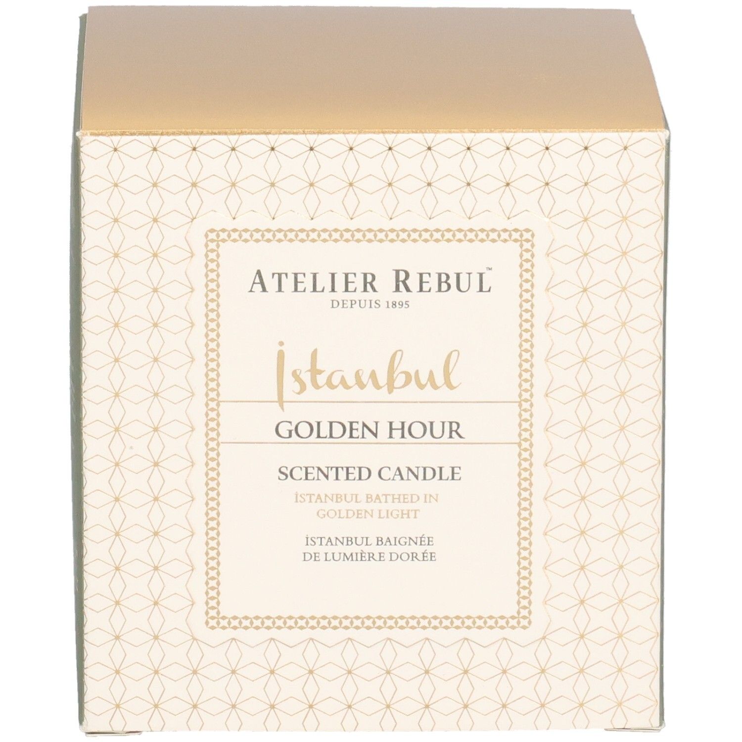 Boîte carrée. Inscription: Atelier Rebul, Istanbul Golden Hour Scented Candle. Couvercle doré, côtés crème avec motif.