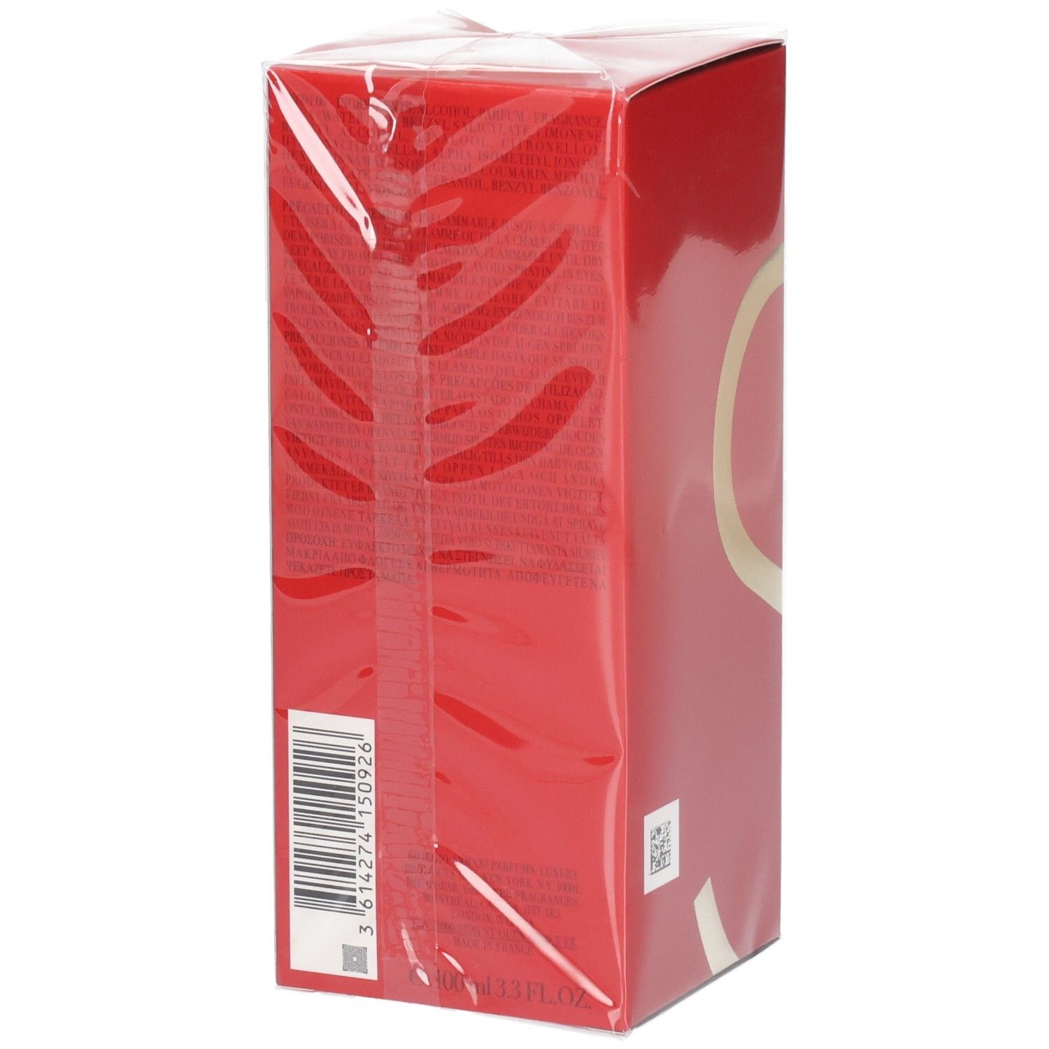 Boîte rouge avec des accents dorés, scellée dans du film plastique transparent. Code-barres et texte visibles sur le côté.