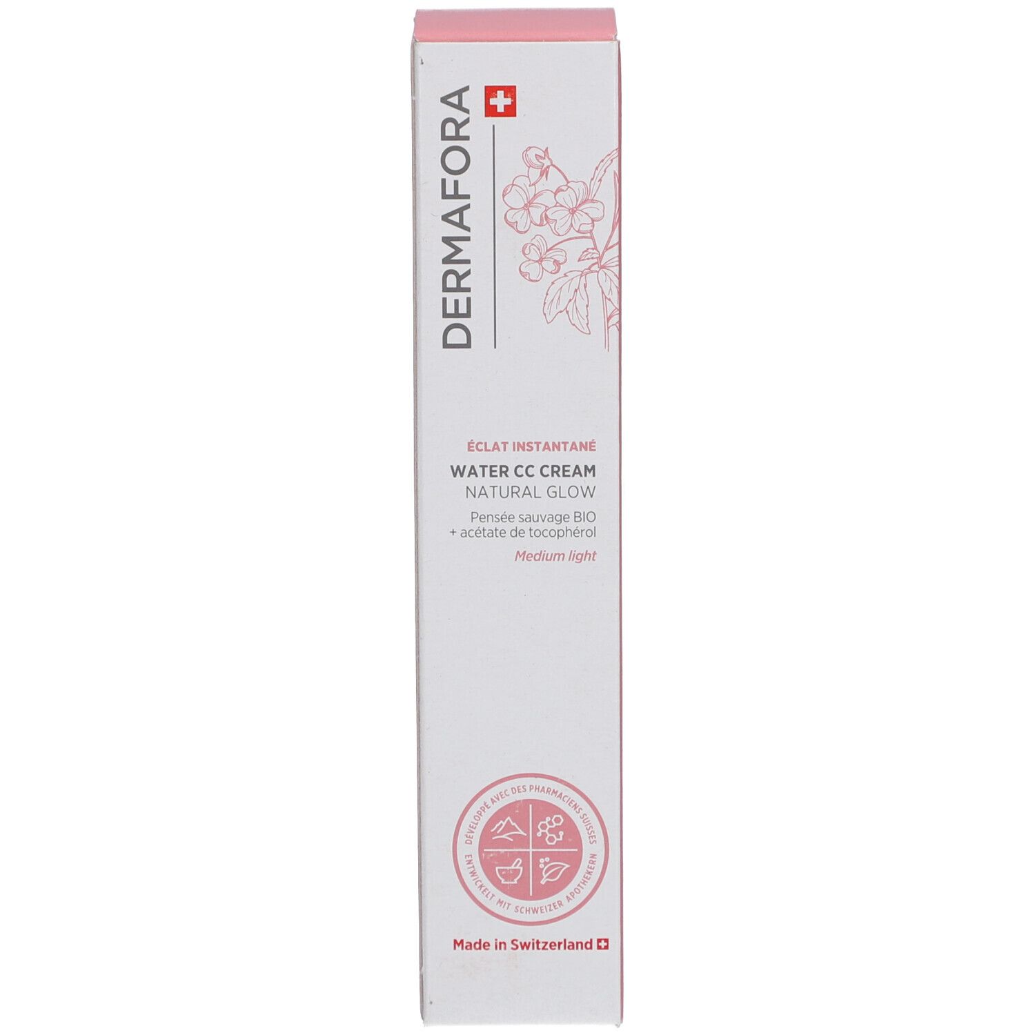 Boîte avec des accents roses. Inscription: Dermafora, Water CC Cream Natural Glow. Croix suisse et motif floral.