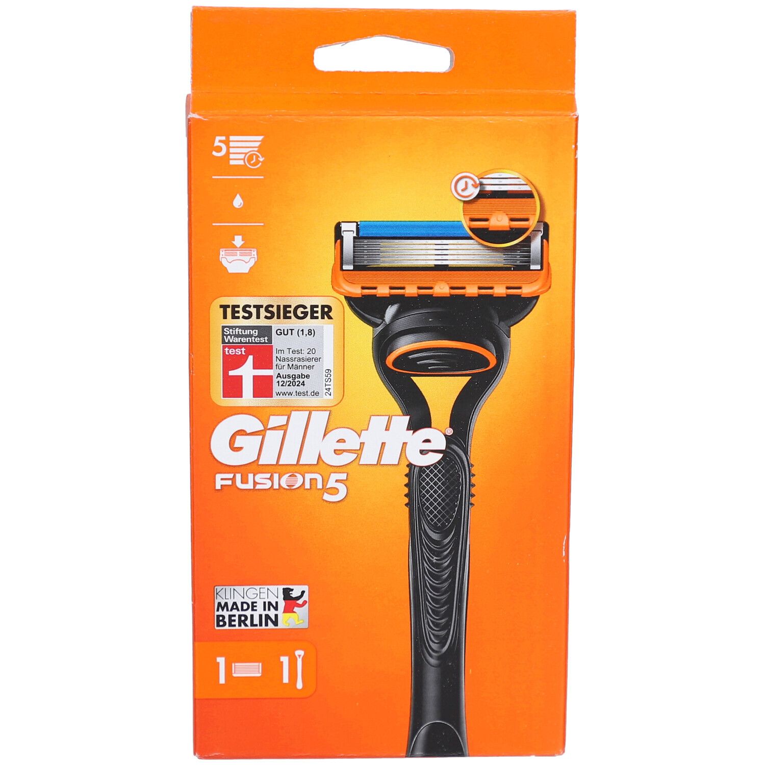 Rasoir dans un emballage orange. Manche noir, tête orange avec lame bleue. Texte: Gillette Fusion5, TestSieger.