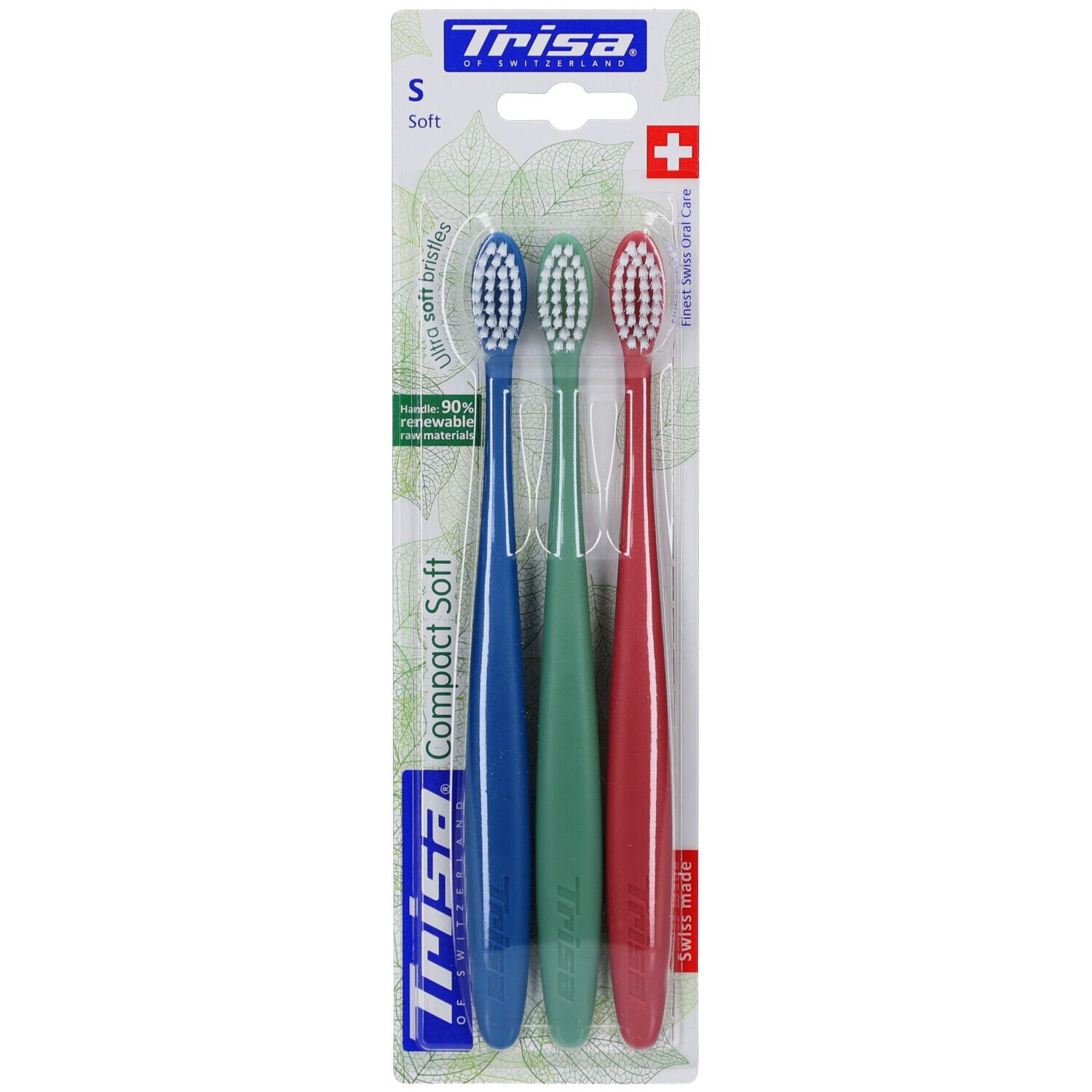 Trois brosses à dents bleues, vertes et rouges. Emballage avec nom du produit et croix suisse. Inscription 'Compact Soft' et 'Trisa'.