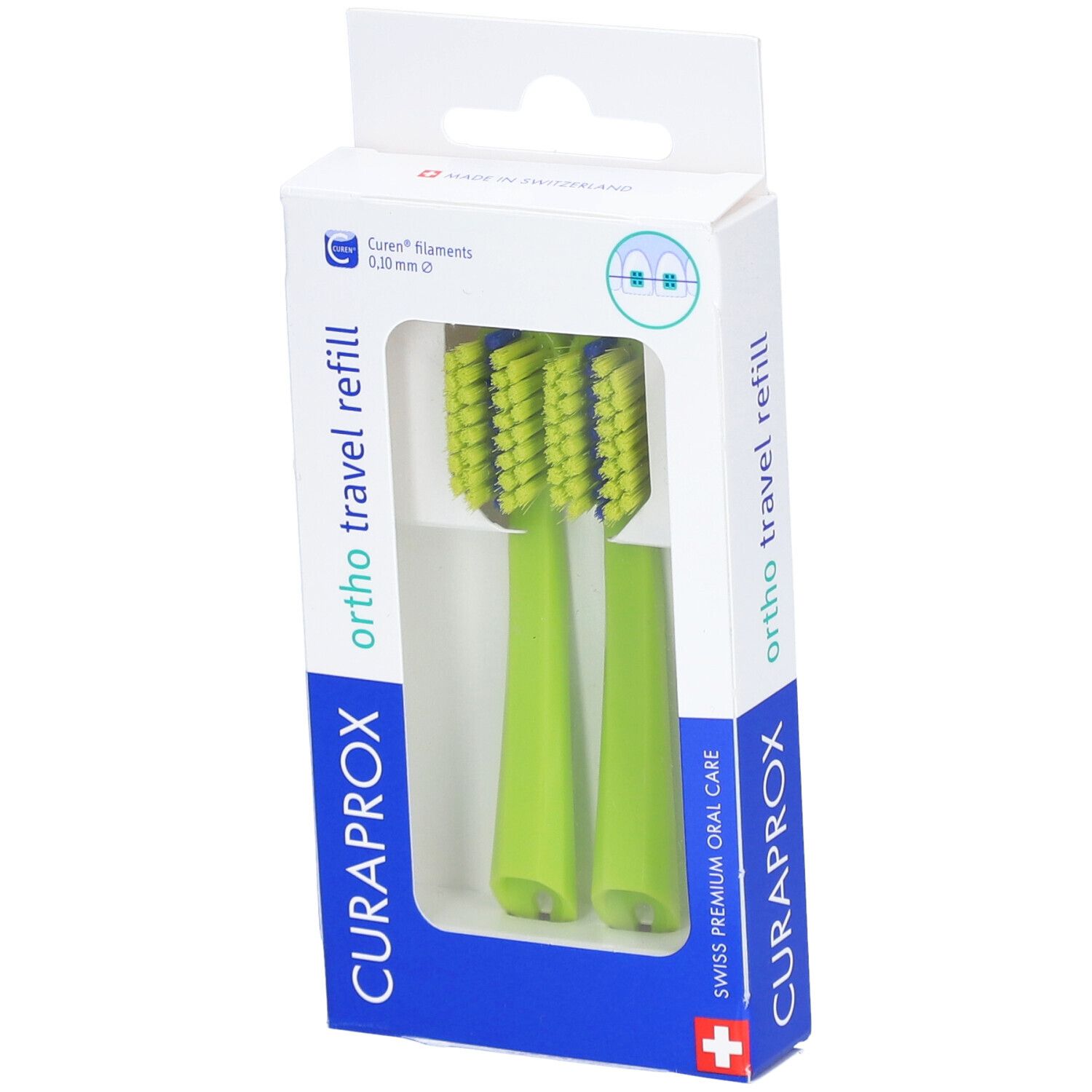 Deux têtes de brosse à dents vertes dans un emballage. Soies bleues. "CURAPROX" et "ortho travel refill" visibles.