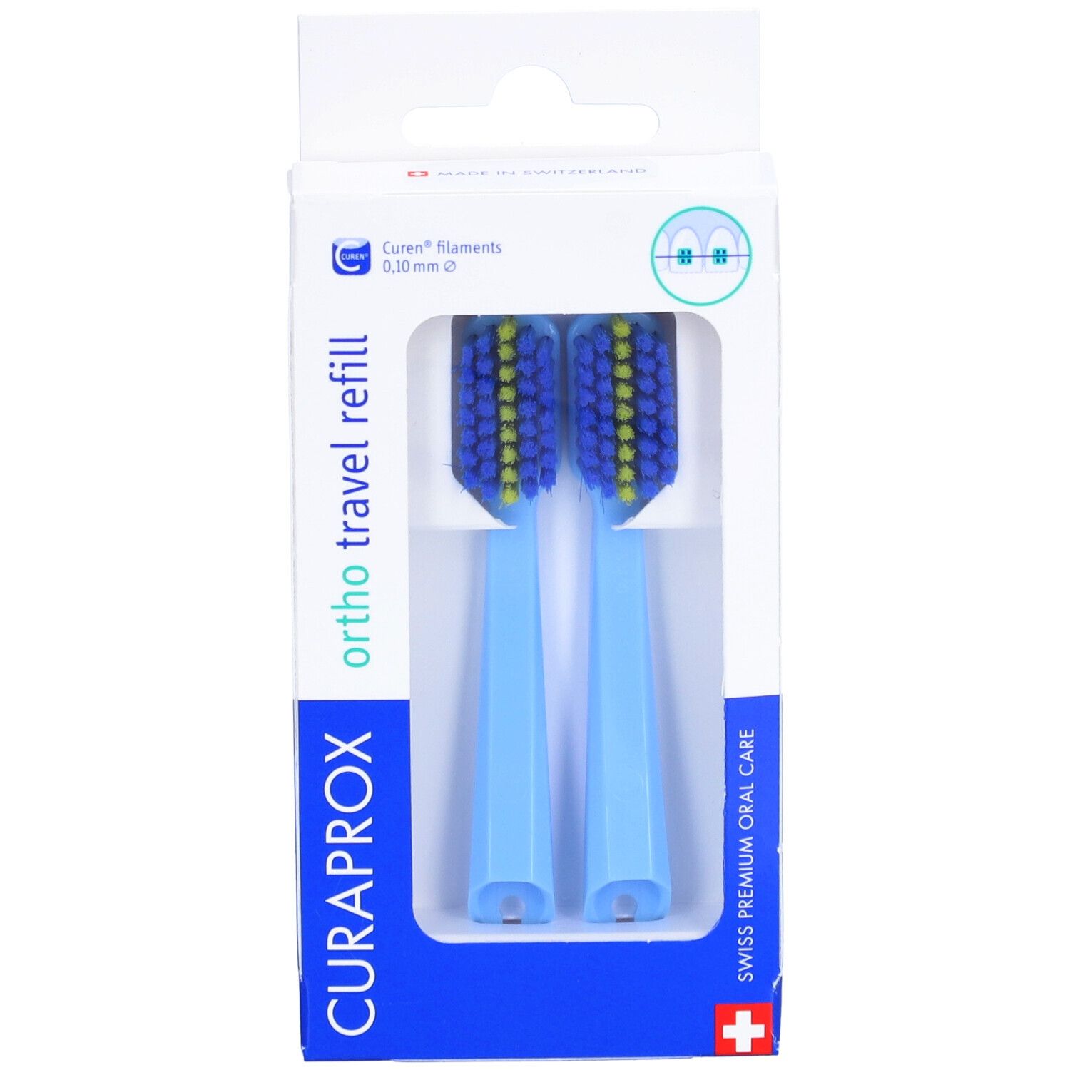 Deux têtes de brosse à dents bleues avec des poils jaunes dans un emballage blanc. Inscription : CURAPROX, ortho travel refill.
