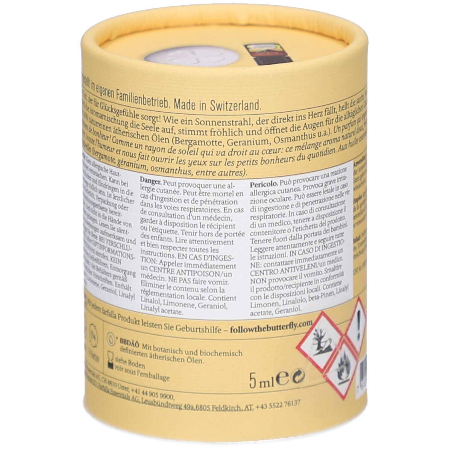 Dos de l'emballage cylindrique. Texte sur les ingrédients, les avertissements de danger. Huiles essentielles botaniques et biochimiques. 5ml. Symboles de danger.