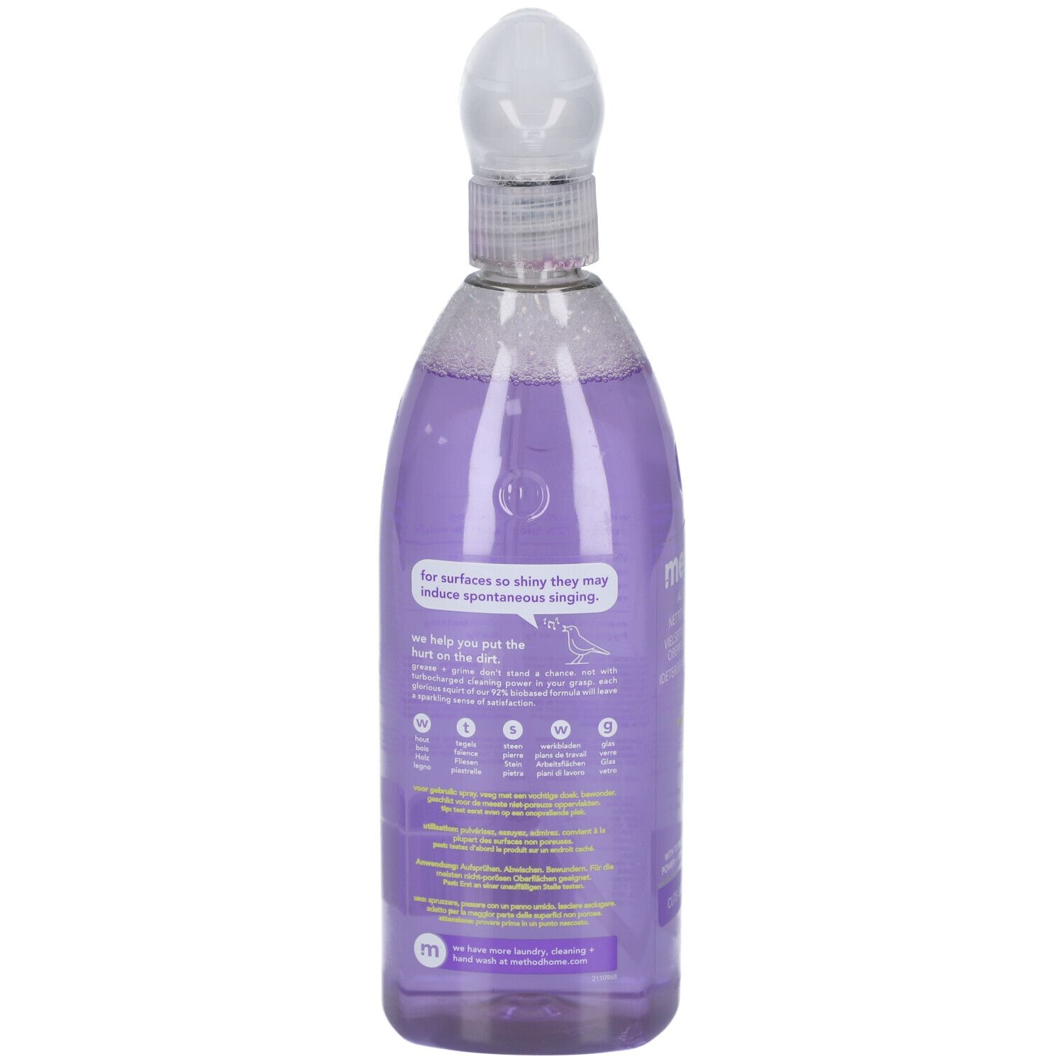 Dos d'un flacon pulvérisateur. Liquide violet visible. Texte : pour des surfaces si brillantes qu'elles chantent spontanément.