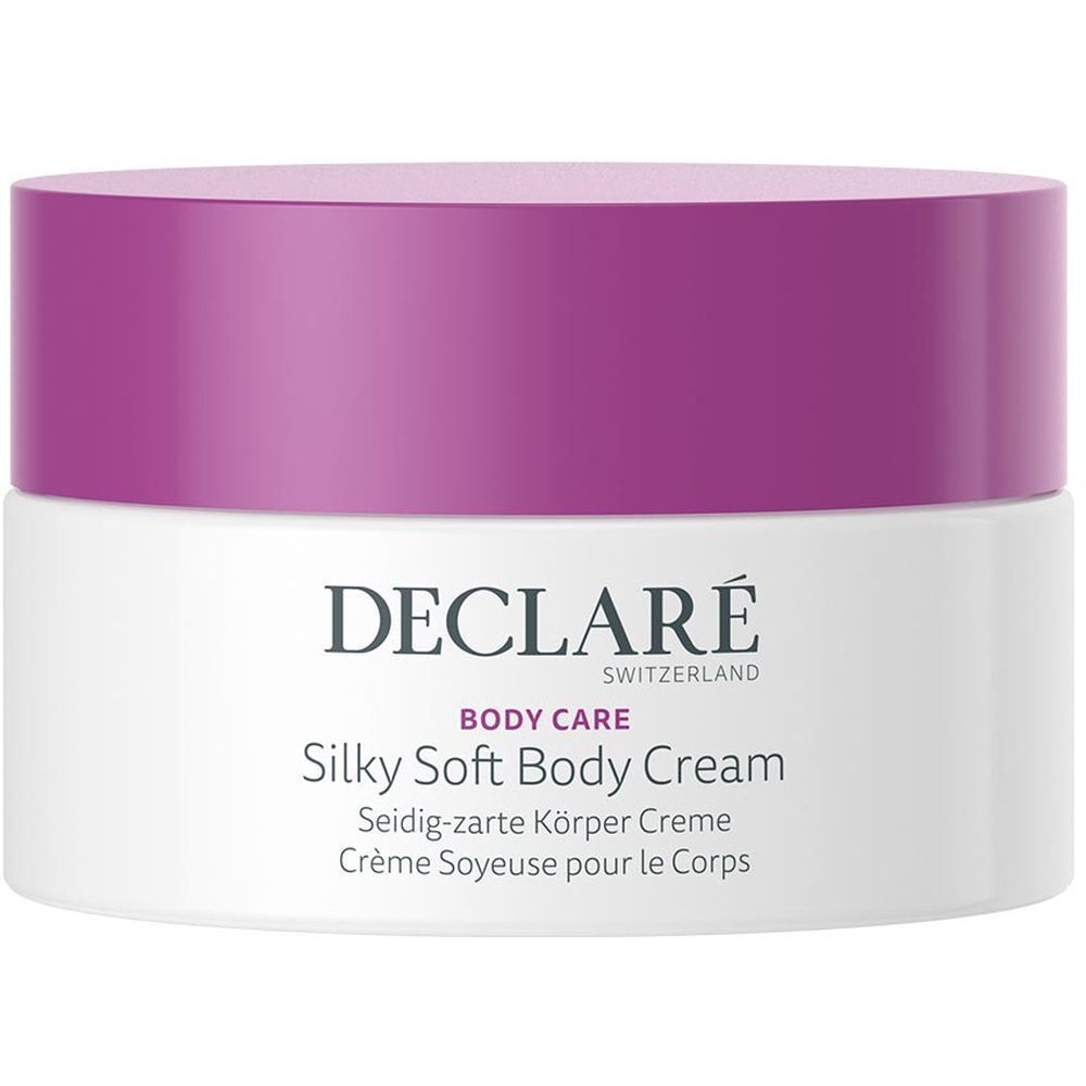 Pot blanc avec couvercle violet. Inscription : DECLARÉ SWITZERLAND, BODY CARE, Silky Soft Body Cream. Désignations multilingues.