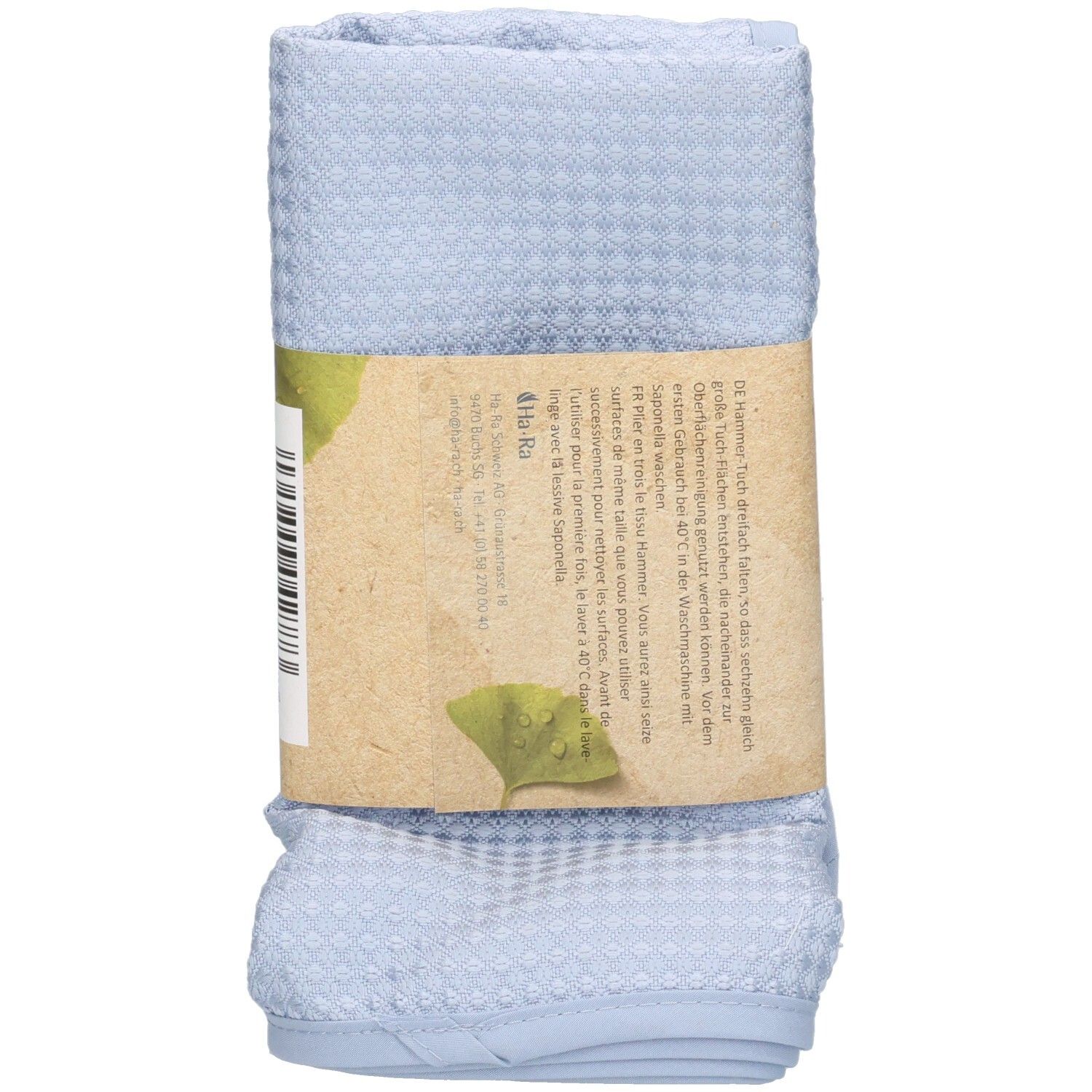 Tissu Hammer bleu roulé avec une bande de papier. Impression: Ha-Ra Professional, nom du produit, texte et logo.
