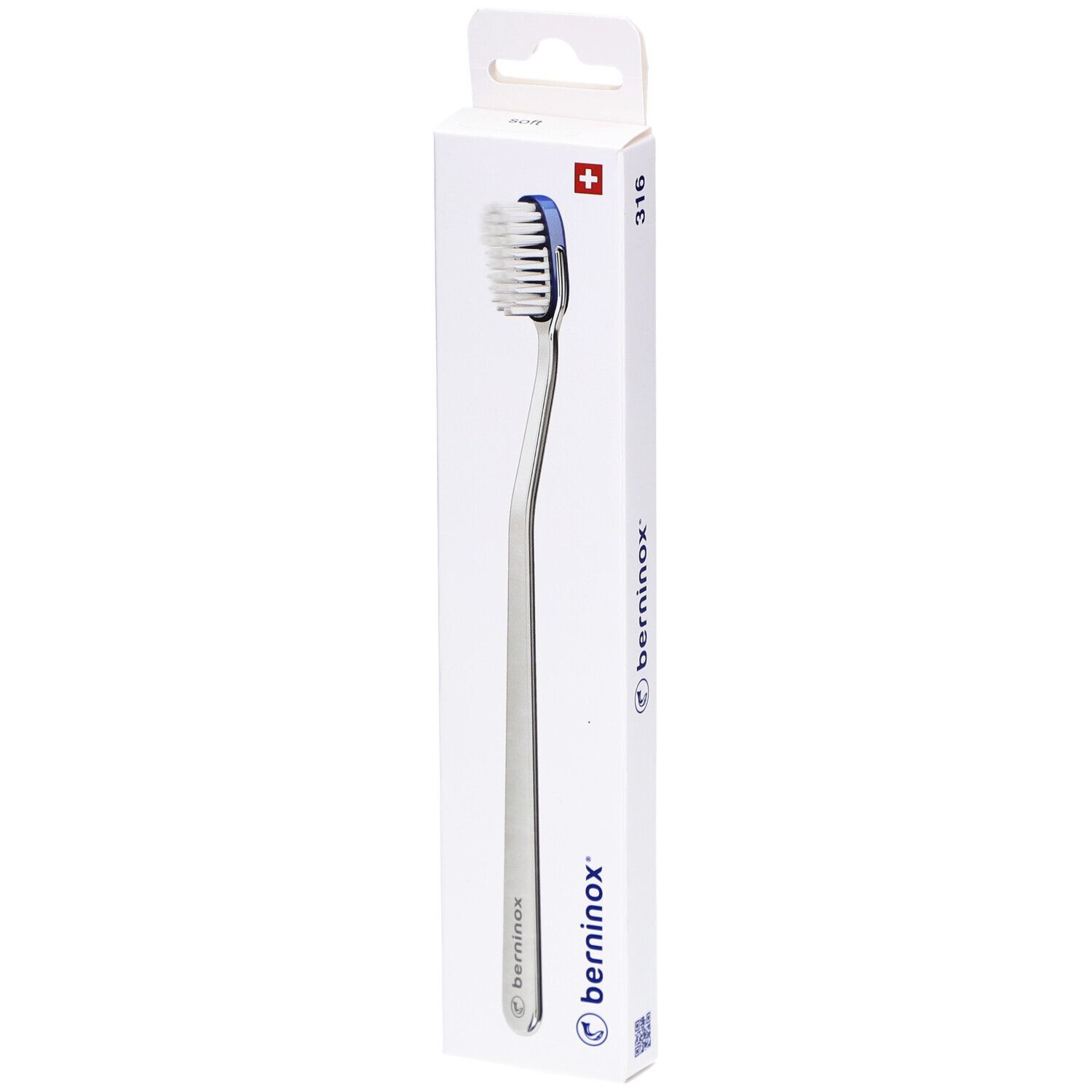 Brosse à dents dans son emballage. Tête blanche, bord bleu, manche argenté. Emballage avec logo et croix suisse.