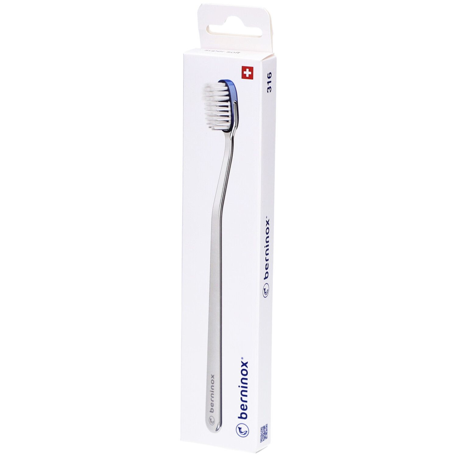 Brosse à dents dans son emballage. Boîte blanche avec nom du produit et croix suisse. Brosse à bord bleu.