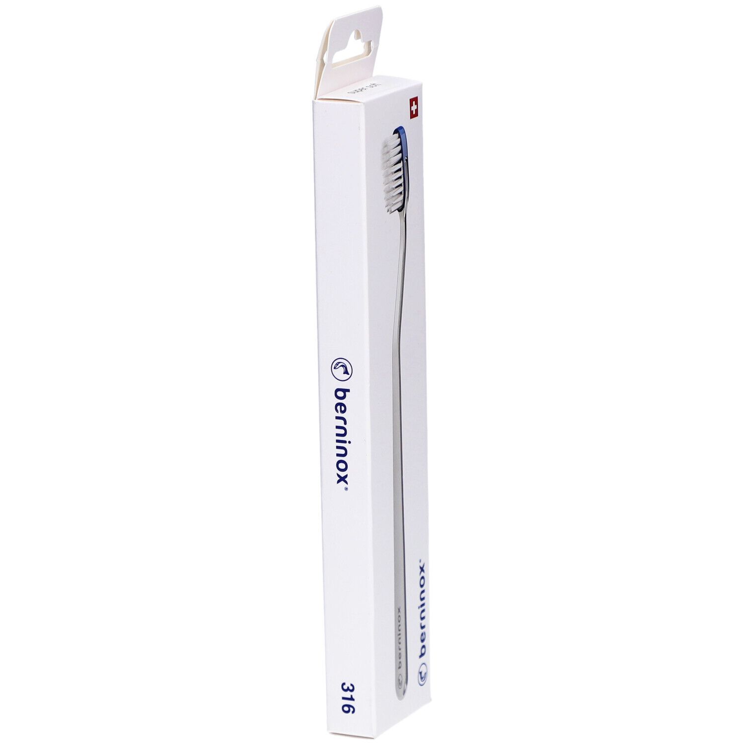 Vue latérale de la brosse à dents dans son emballage. Boîte blanche avec nom du produit et croix suisse. Brosse visible.