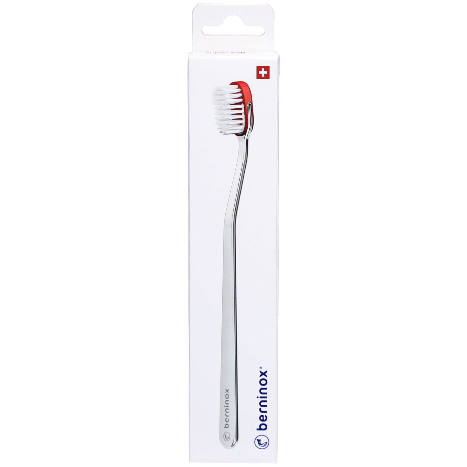 Brosse à dents dans emballage. Tête rouge, poils blancs, manche argenté. Marque Berninox, croix suisse.