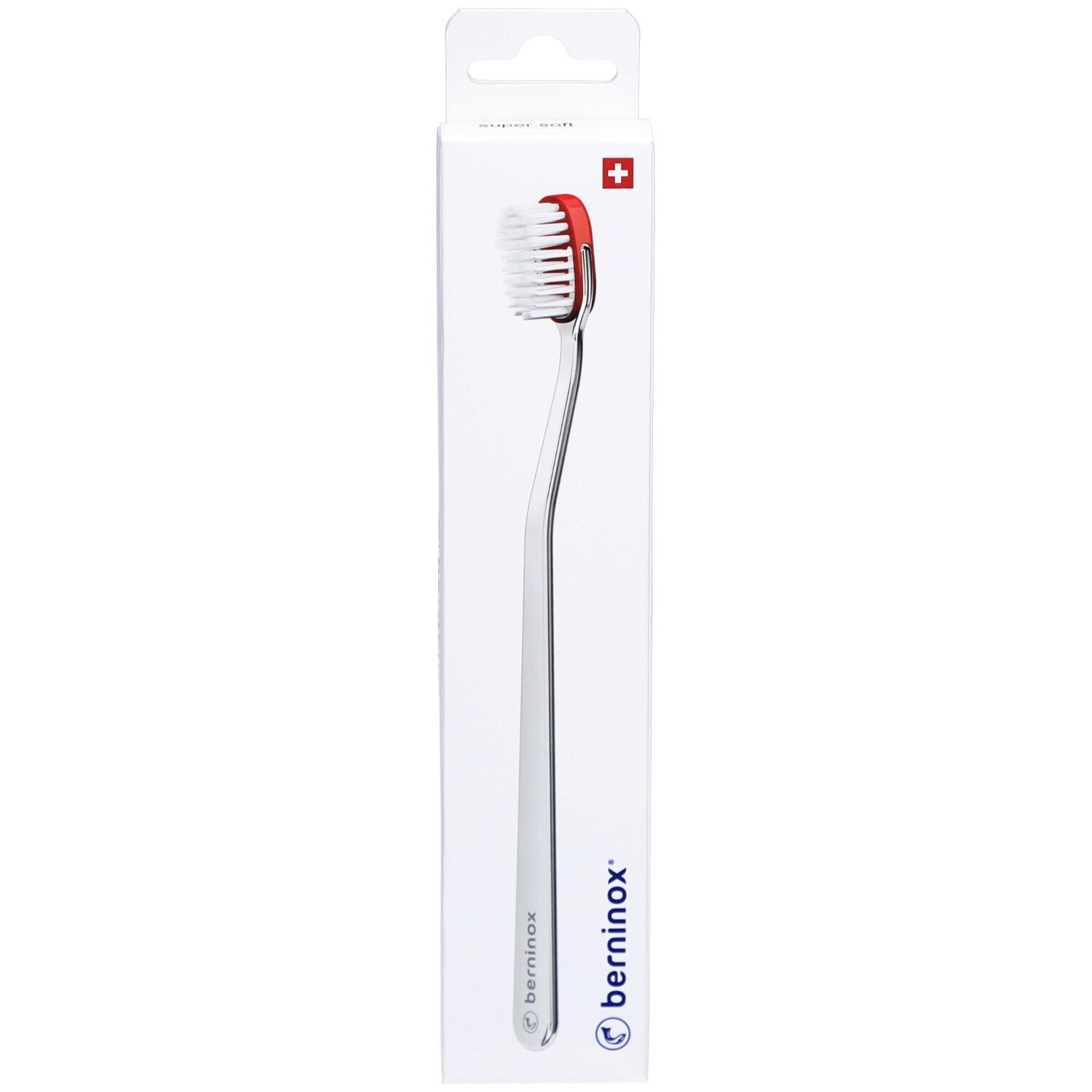 Brosse à dents dans emballage. Tête rouge, poils blancs, manche argenté. Marque Berninox, croix suisse.