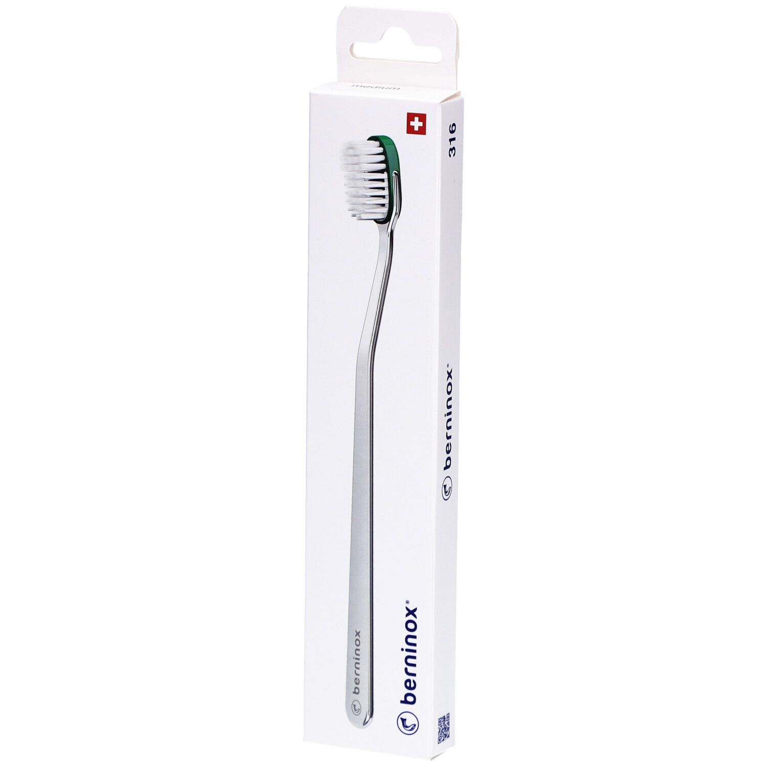 Brosse à dents dans son emballage. Manche argenté, tête verte et blanche. Marque Berninox.