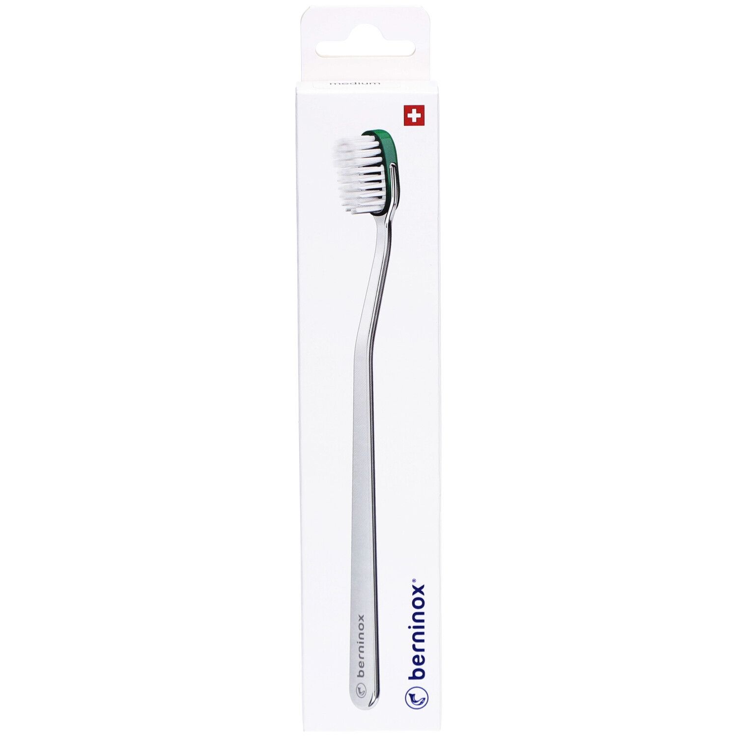 Brosse à dents dans son emballage. Manche argenté, tête verte et blanche. Marque Berninox.