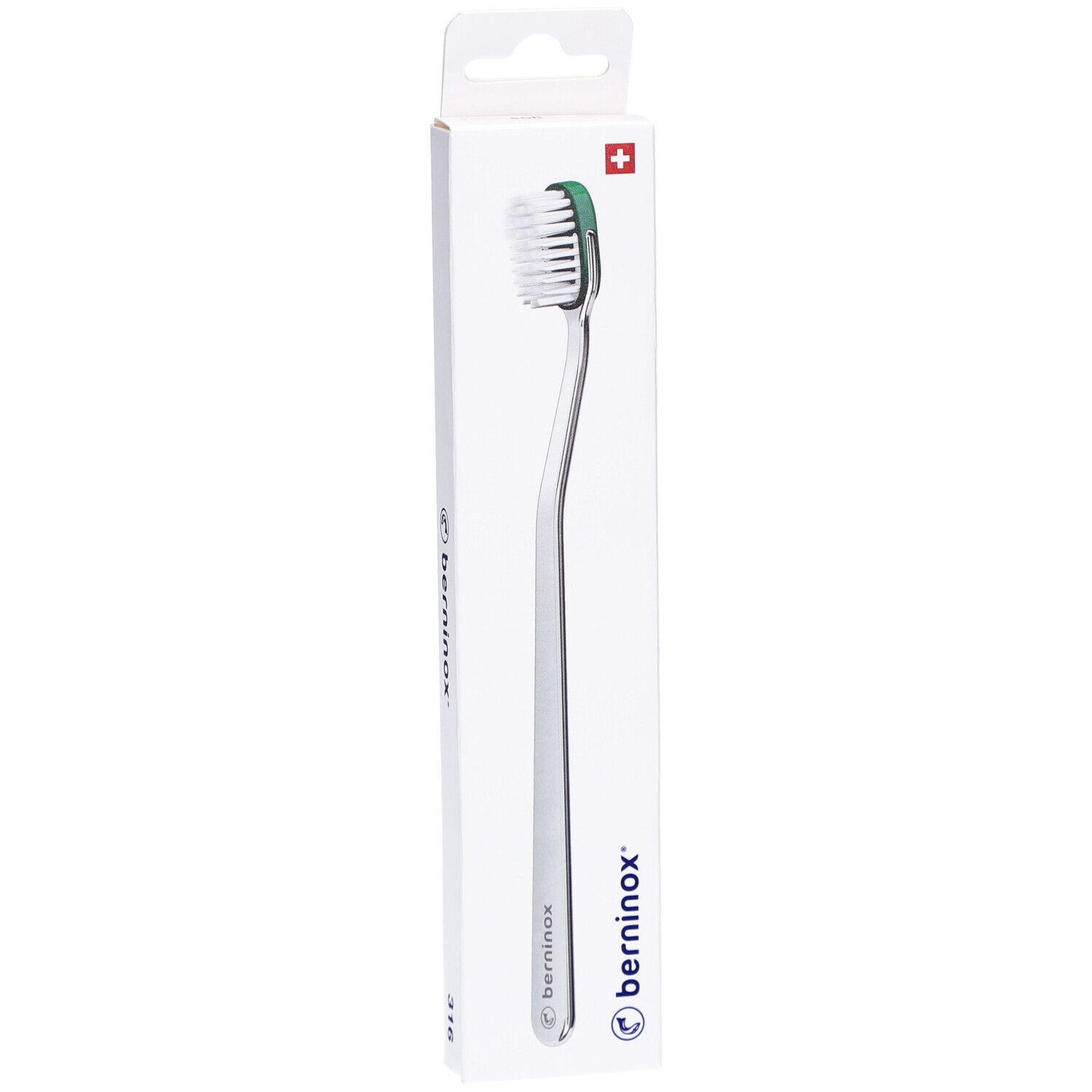Brosse à dents dans son emballage. Manche argenté, tête verte avec poils blancs. Emballage avec logo et croix suisse.