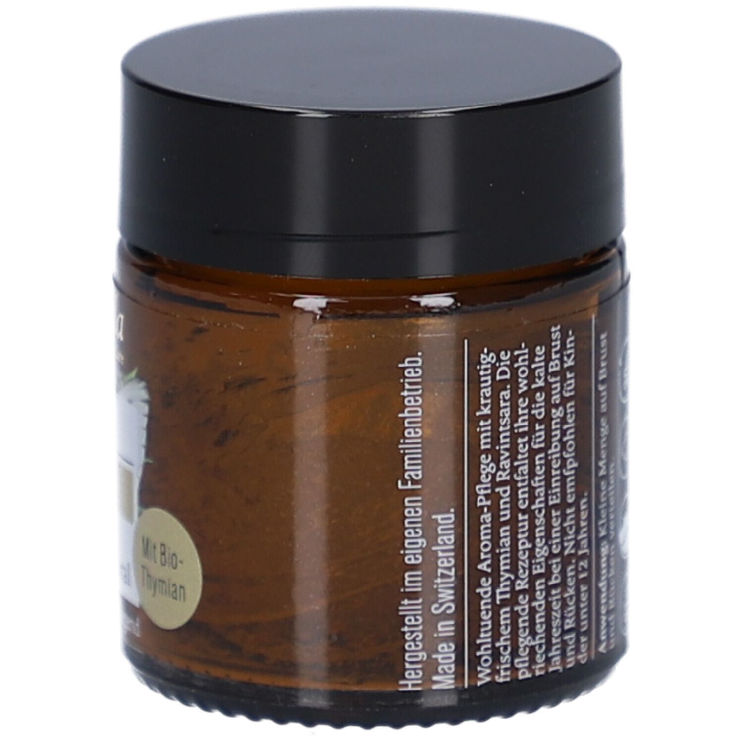 Pot en verre brun avec couvercle noir. Étiquette avec texte: Fabriqué en Suisse. Texte: Appliquer une petite quantité sur la poitrine et le dos.