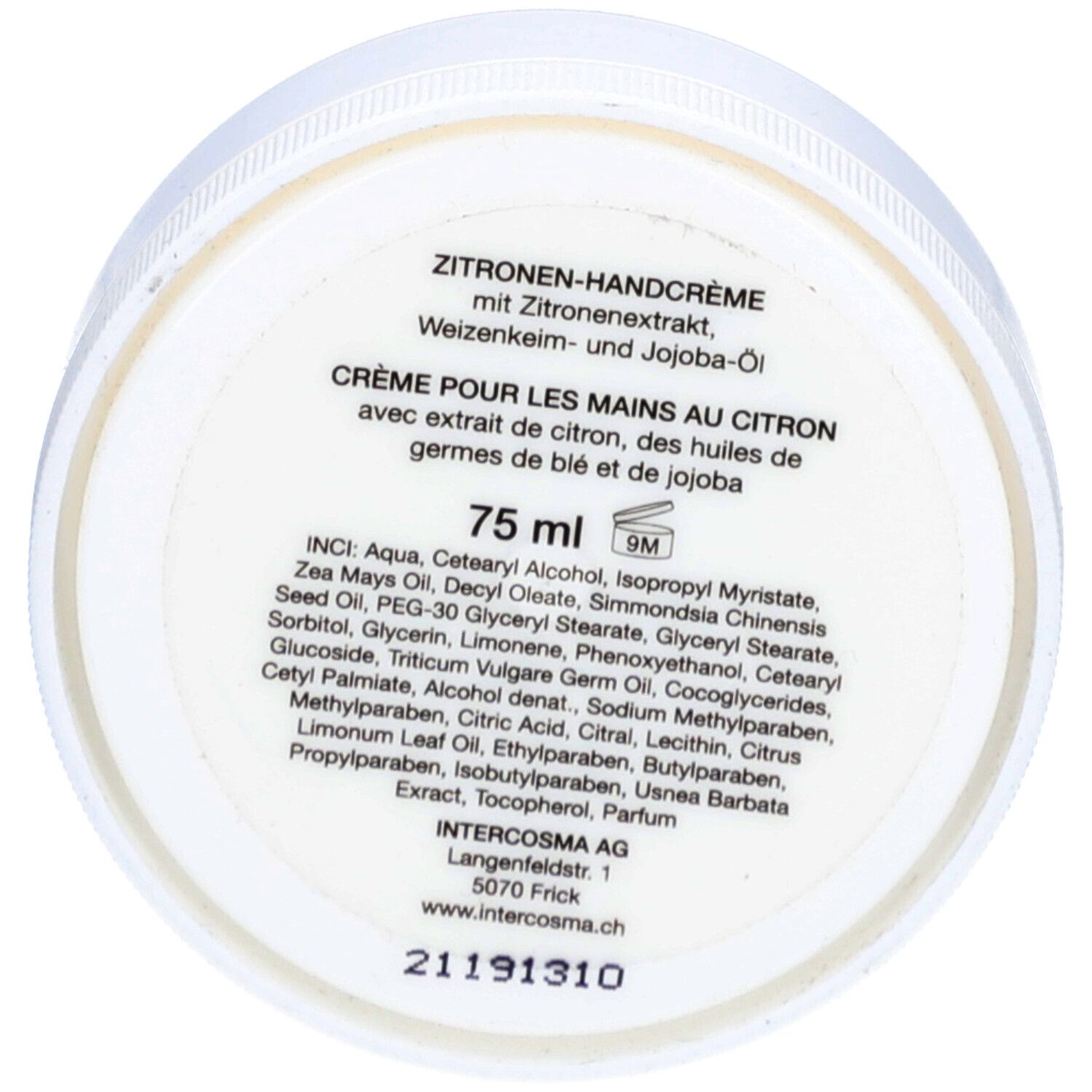 Fond d'un pot blanc avec texte. Crème pour les mains au citron, ingrédients, informations fabricant. Écriture noire.