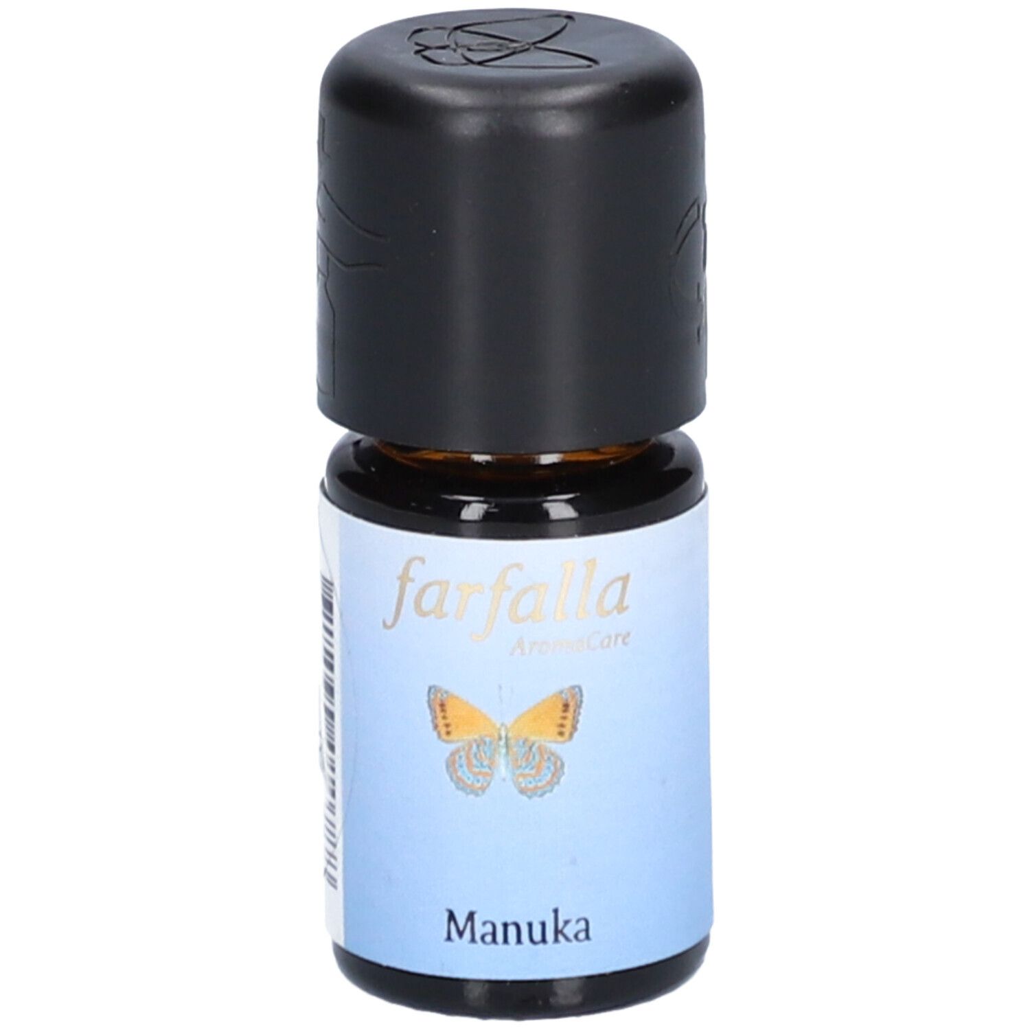 Flacon en verre brun avec bouchon noir. Étiquette avec papillon et texte "Manuka".