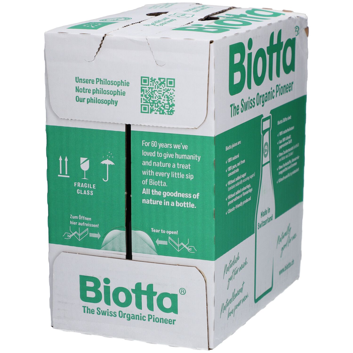 Carton avec logo BIOTTA et texte : "The Swiss Organic Pioneer". Contient des informations sur les jus bio. Inscription : "Made in Switzerland".