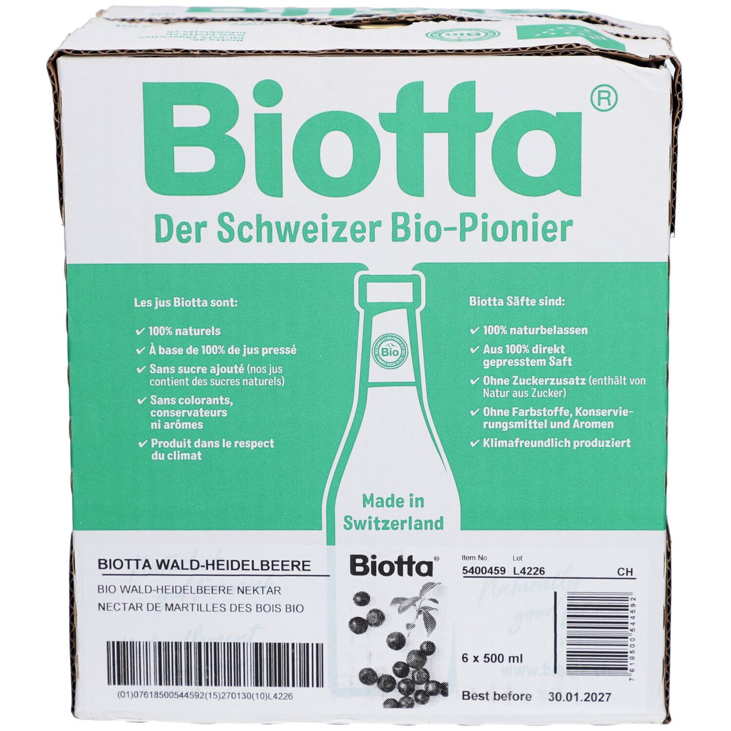 Carton de BIOTTA Waldheidelbeere Bio. Six bouteilles, emballage vert et blanc. Texte: Le pionnier bio suisse. Étiquette produit.