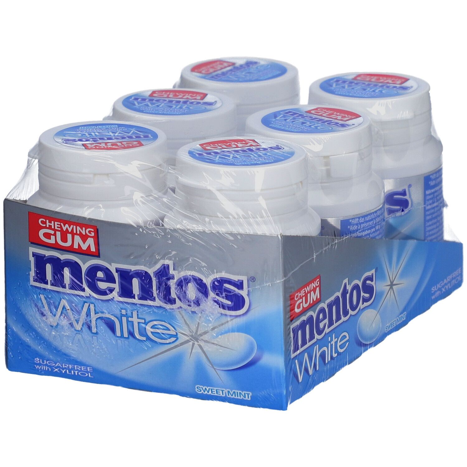 Six bouteilles de chewing-gum Mentos White dans un emballage. Inscription : Mentos White, sans sucre avec du xylitol. Menthe douce.