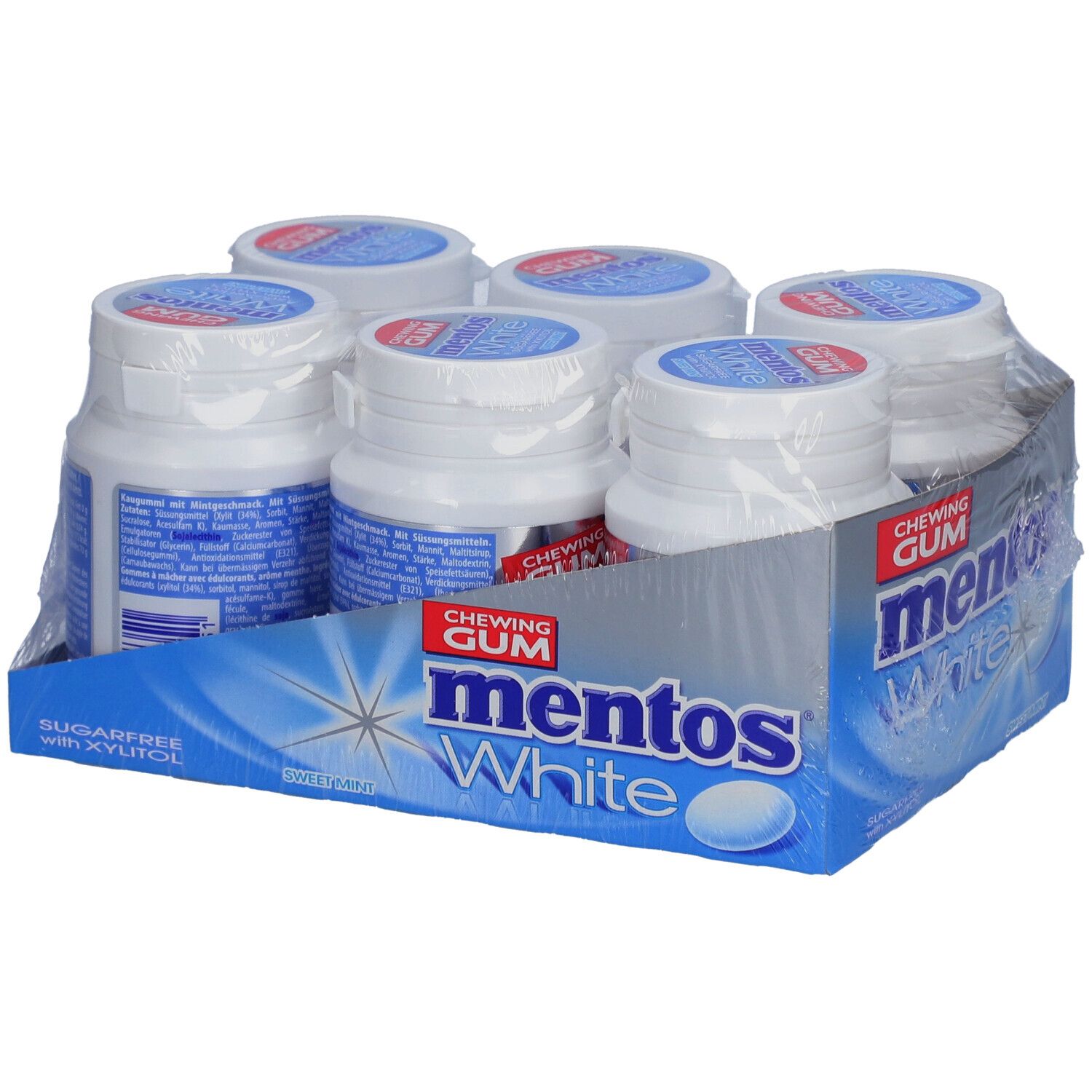 Six bouteilles de chewing-gum Mentos White dans un emballage. Inscription : Mentos White, sans sucre avec du xylitol. Menthe douce.
