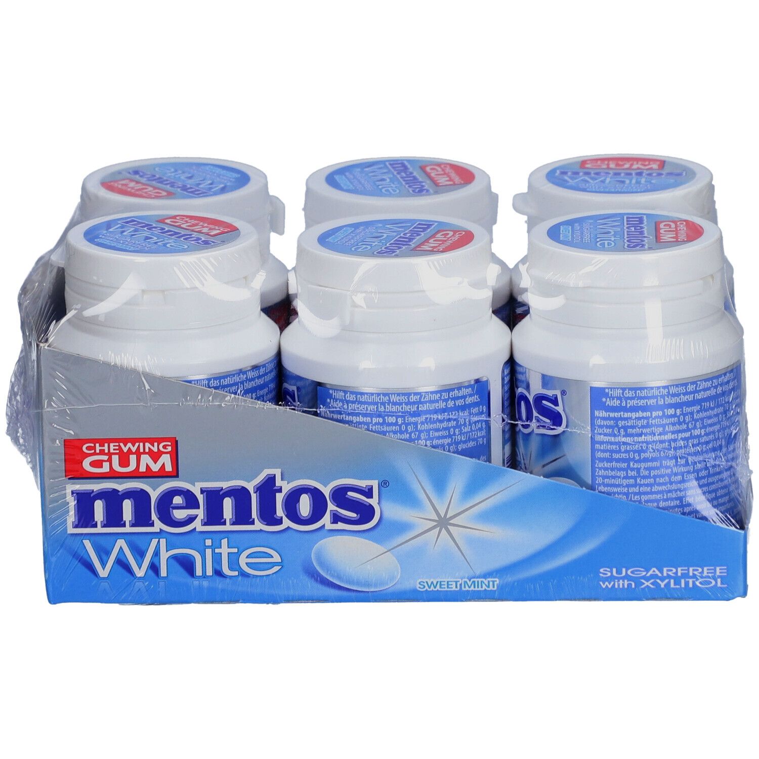 Six bouteilles de chewing-gum Mentos White dans un emballage. Inscription : Mentos White, sans sucre avec du xylitol. Menthe douce.