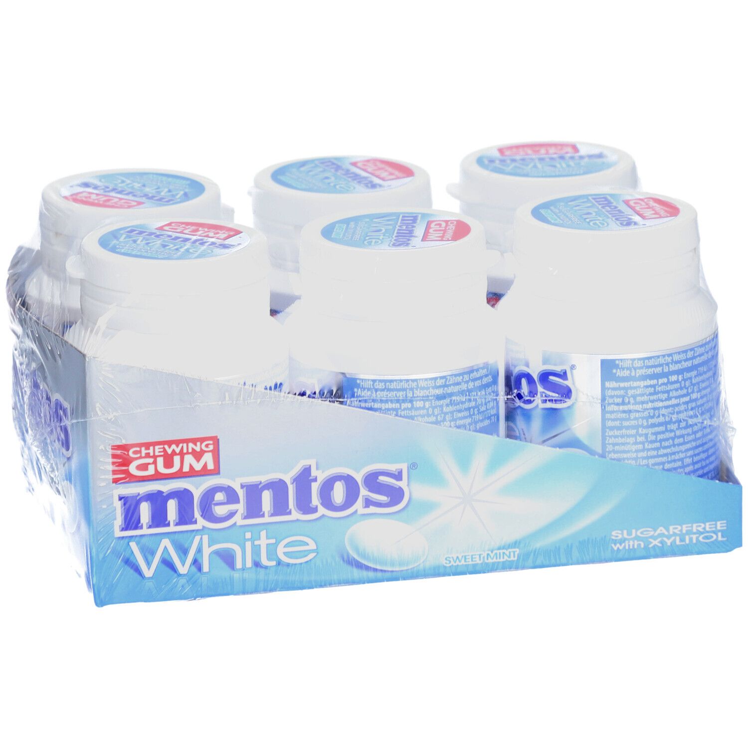 Six bouteilles de chewing-gum Mentos White dans un emballage. Inscription : Mentos White, sans sucre avec du xylitol. Menthe douce.