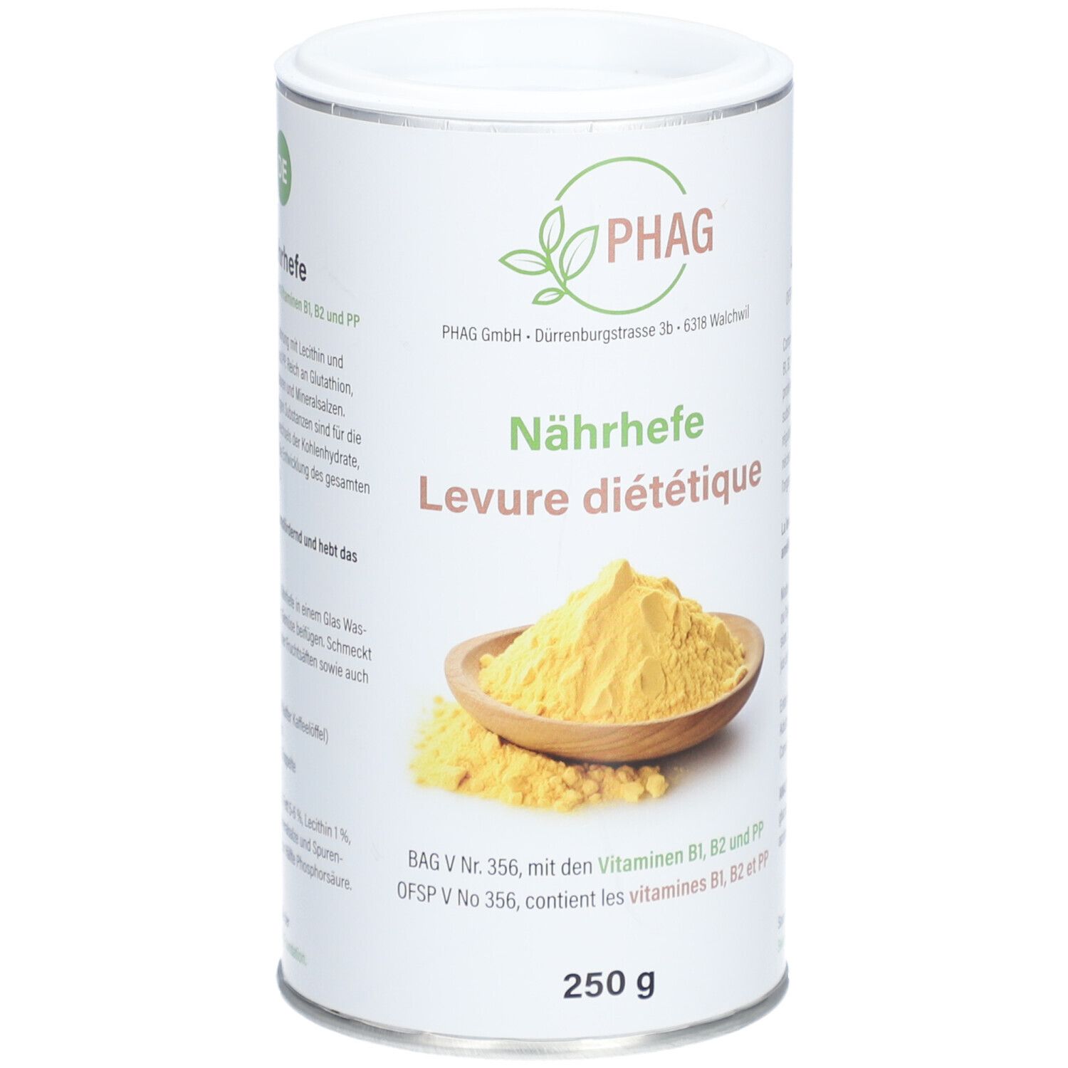 Boîte cylindrique avec logo PHAG et inscription "Nährhefe Levure diététique". En dessous, 250 g. Poudre jaune dans un bol en bois.