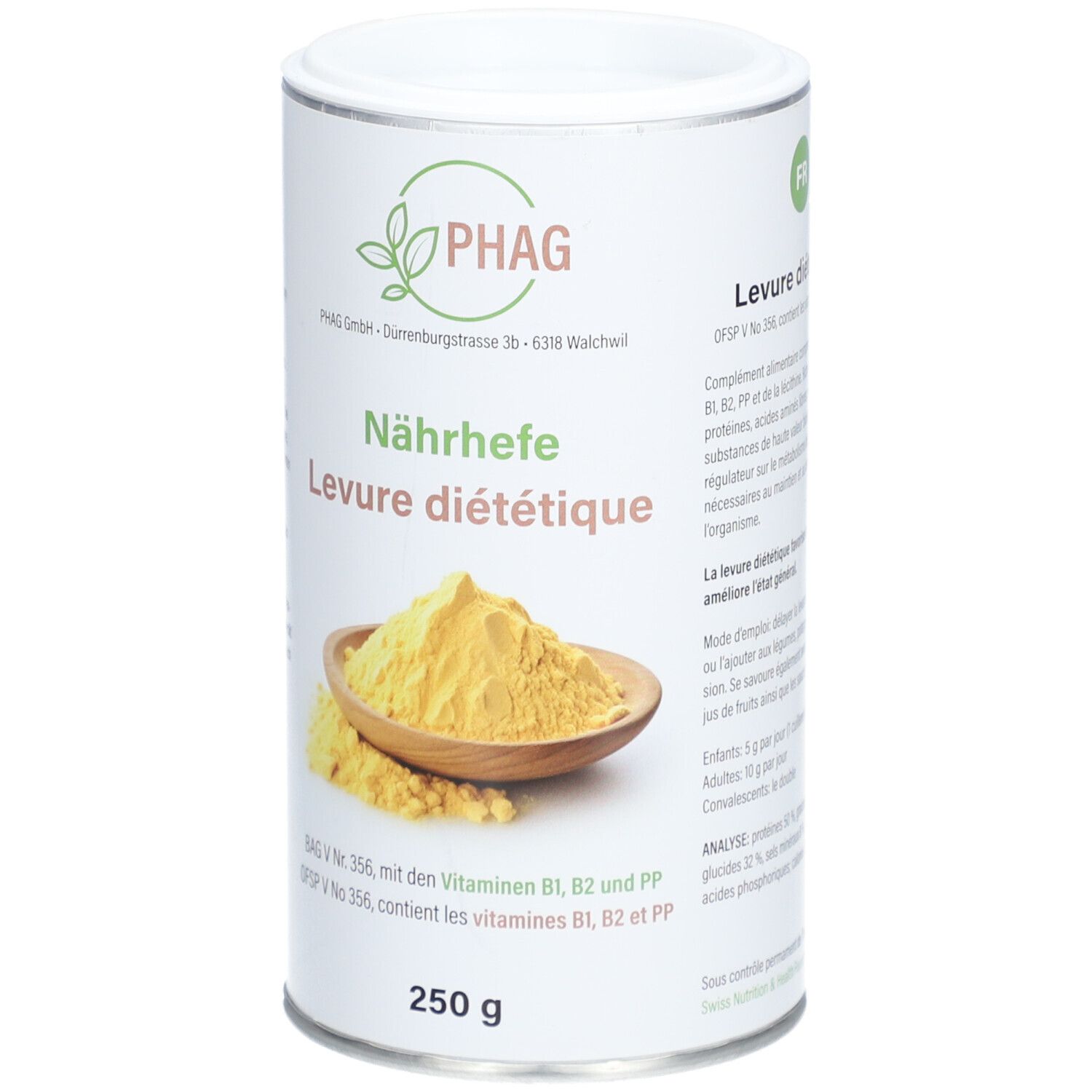 Boîte cylindrique avec logo PHAG et inscription "Nährhefe Levure diététique". En dessous, 250 g. Poudre jaune dans un bol en bois.