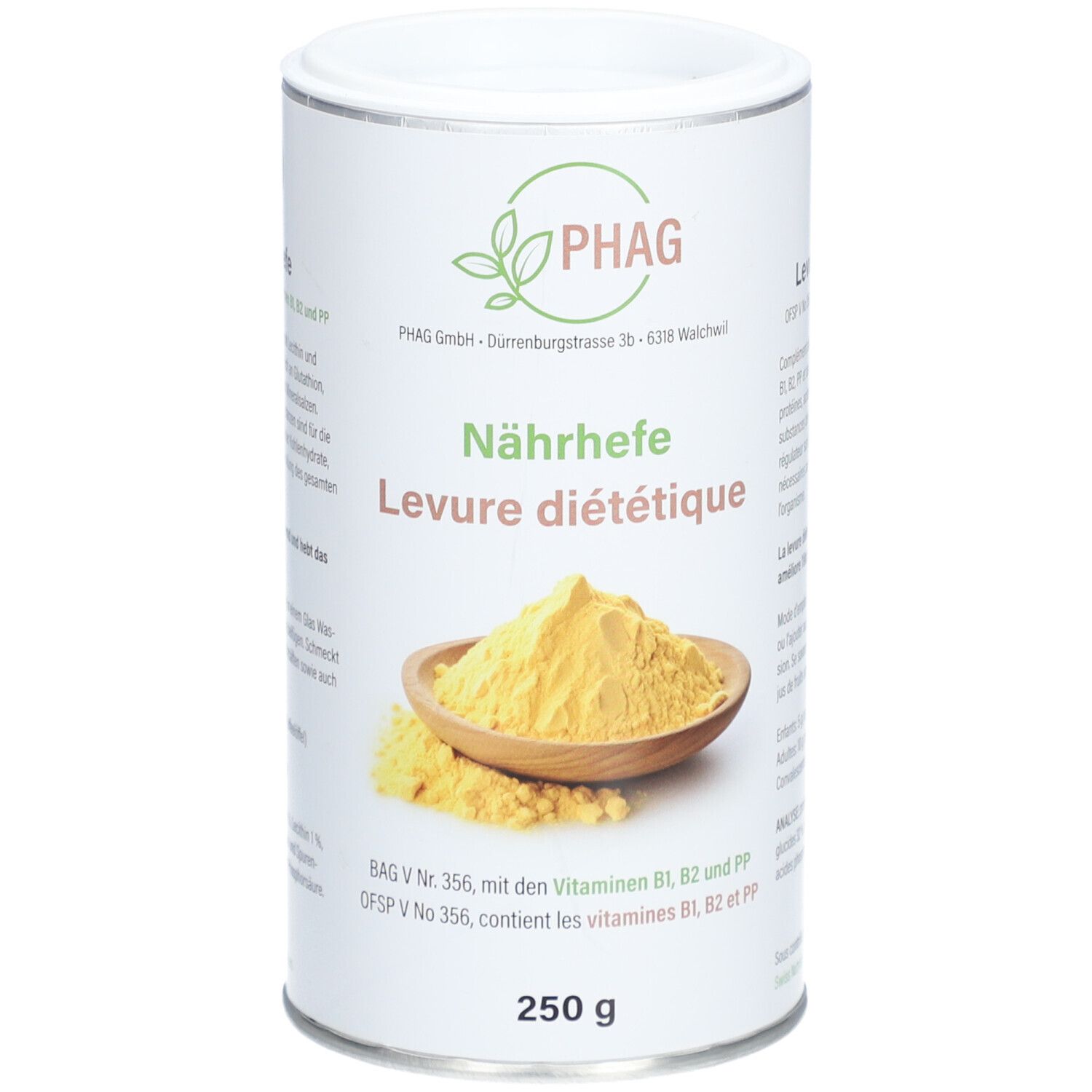 Boîte cylindrique avec logo PHAG et inscription "Nährhefe Levure diététique". En dessous, 250 g. Poudre jaune dans un bol en bois.