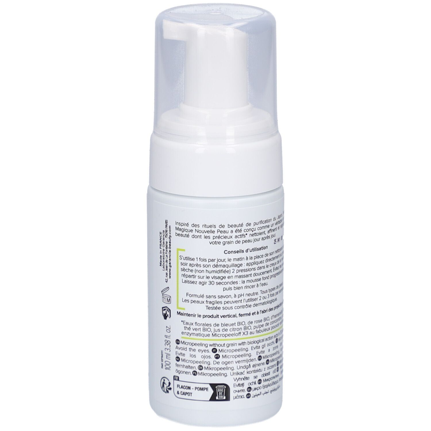 Flacon blanc avec pompe. Inscription: GARANCIA, Pschitt Magique, Nouvelle Peau, Visage. Texte en français.