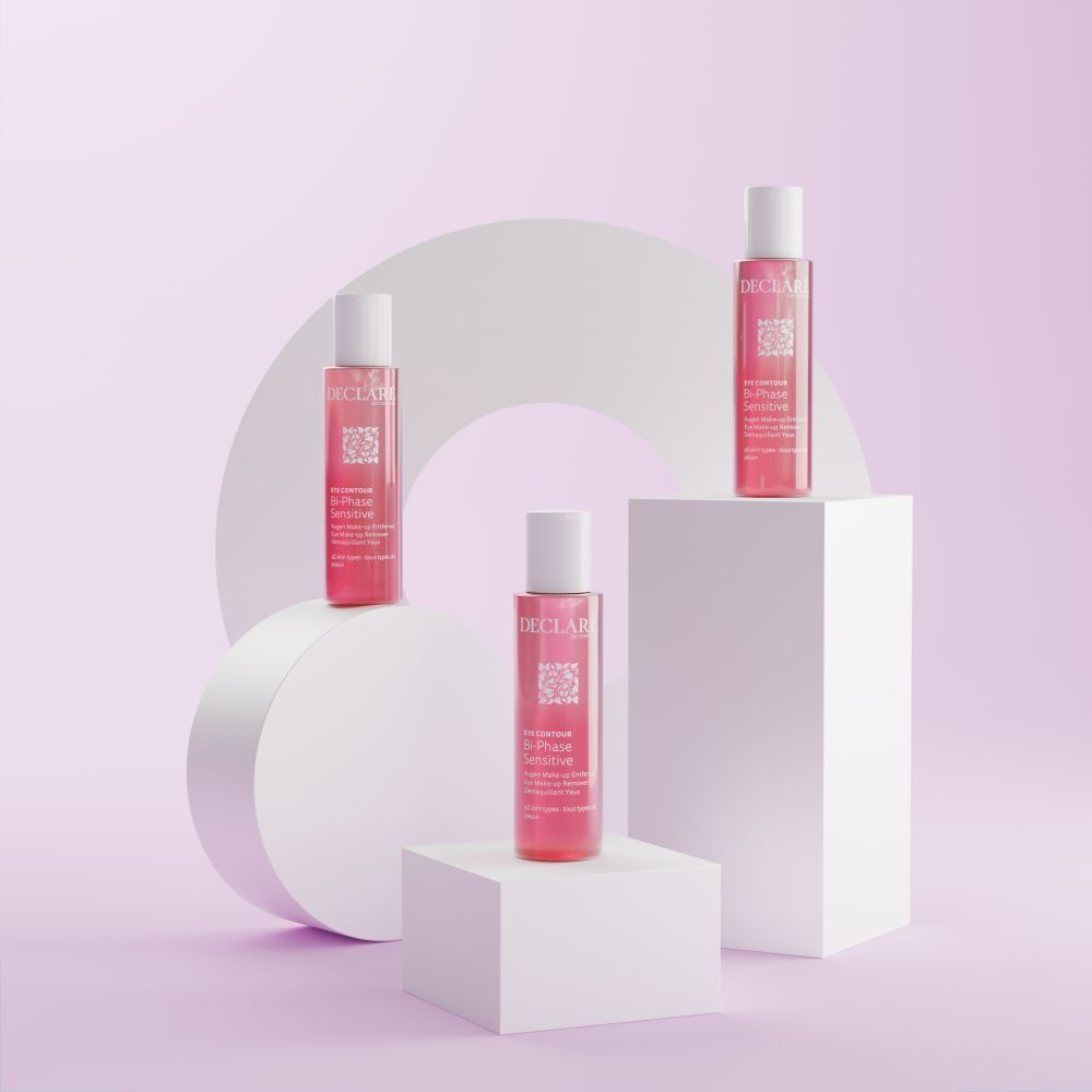 Trois flacons de liquide rose sur des blocs blancs. Fond avec cercle et élément blanc.