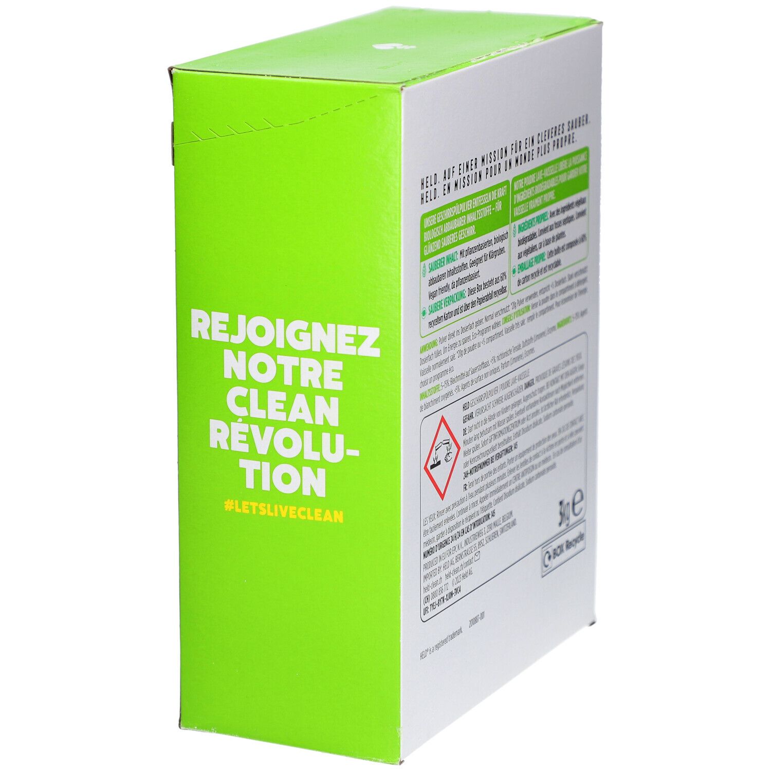 Côté de la boîte de poudre pour lave-vaisselle HELD avec surface verte, texte 'Rejoignez notre clean révolution' et symboles d'avertissement.