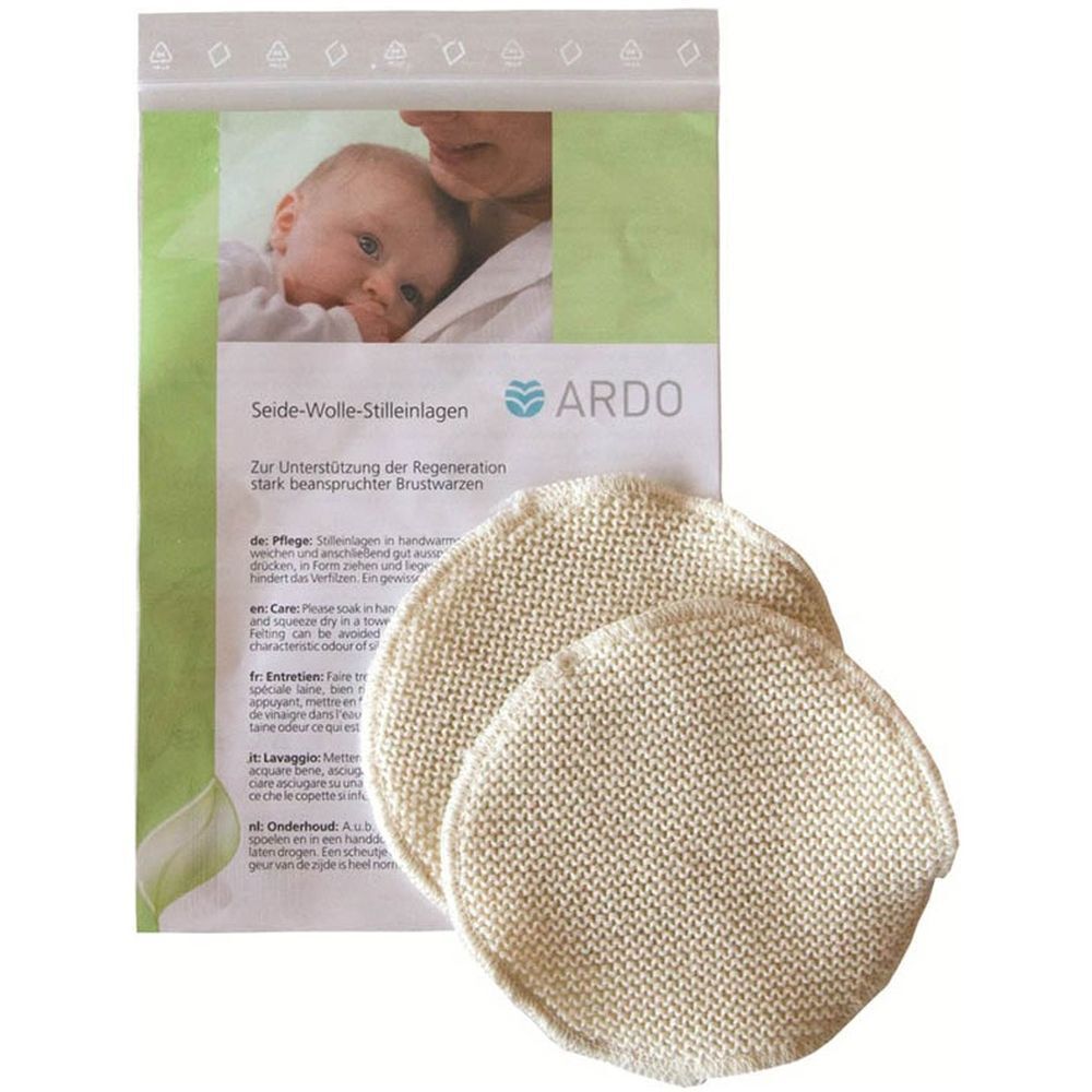 Deux coussinets d'allaitement ronds en tricot, mélange soie-laine. Emballage avec image de bébé et logo ARDO.