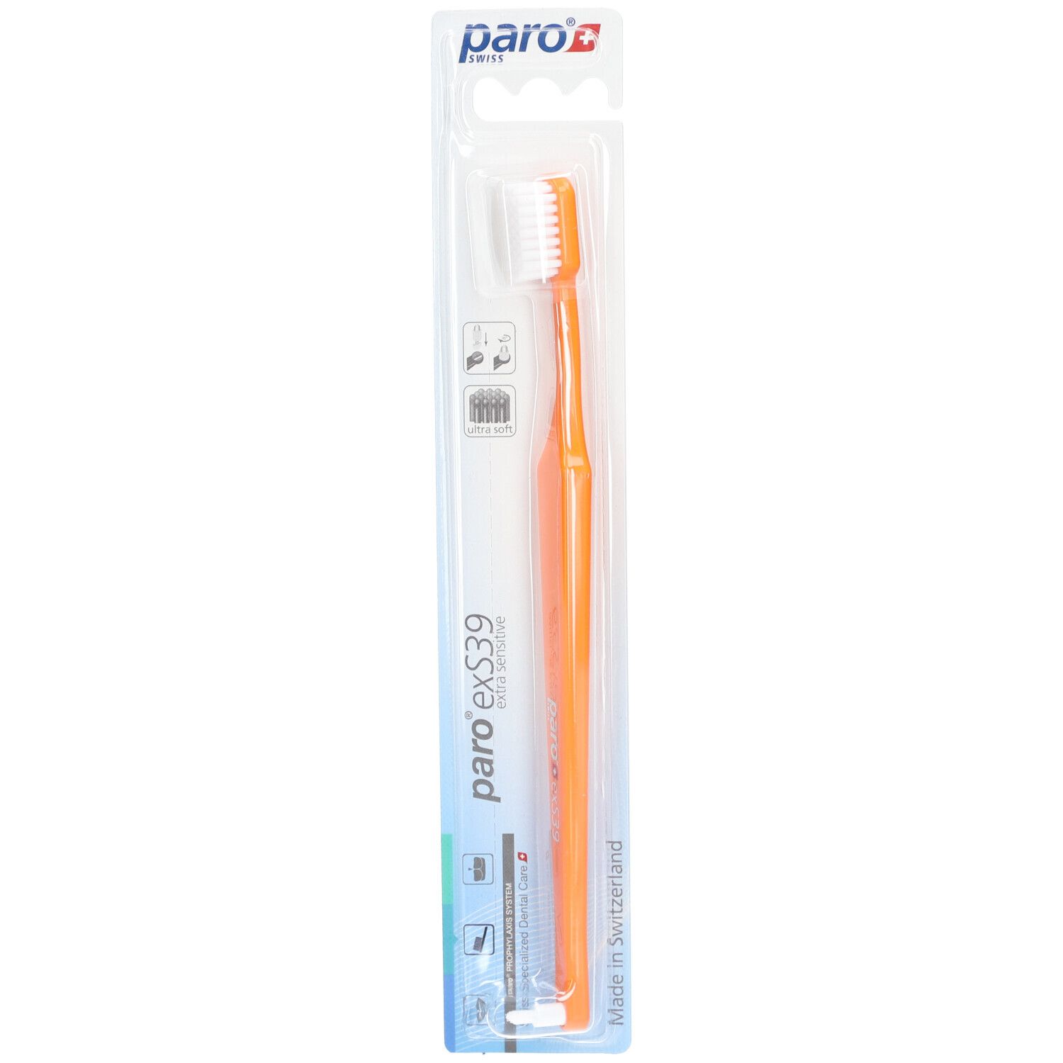 Brosse à dents orange avec tête blanche, emballage blister. Marque et nom du produit visibles.