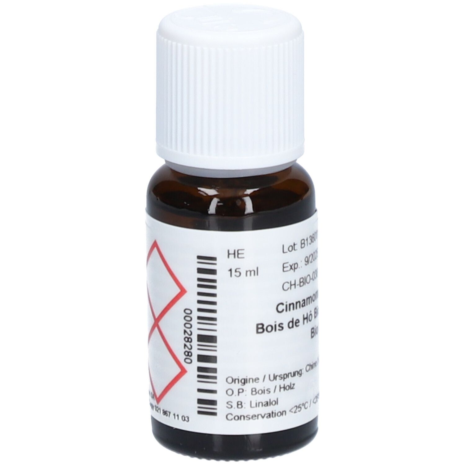 Flacon en verre brun avec bouchon blanc. Étiquette avec symbole de danger et informations produit. Texte: Cinnamomum, Bois de Hô Bio, 15 ml.