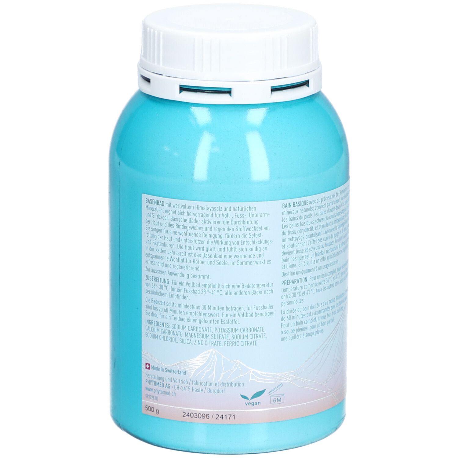 Boîte turquoise avec couvercle blanc. Texte au dos. Liste des ingrédients. Motif montagne. Croix suisse. Vegan.