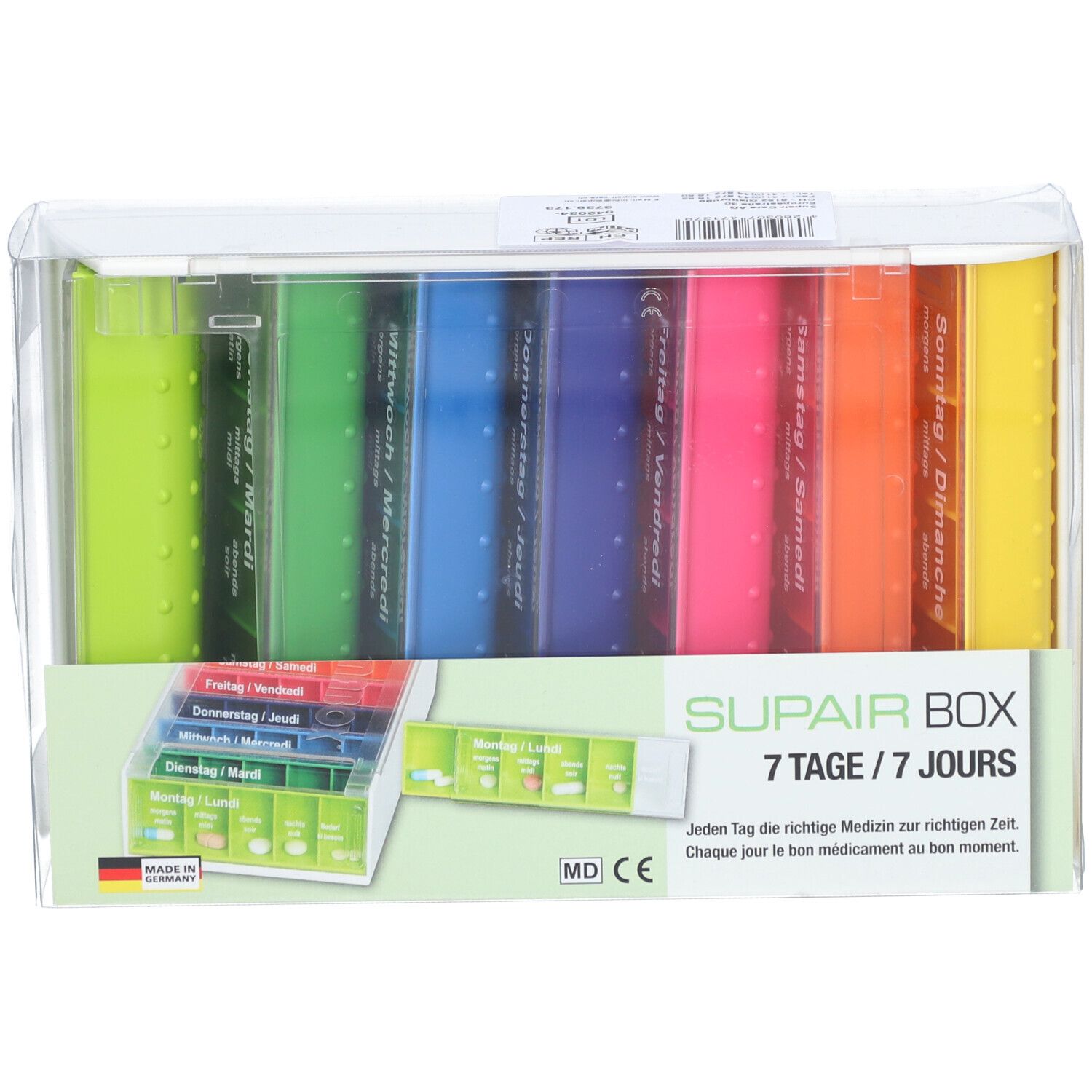 SUPAIRBOX Semainier Rainbow. Boîte à pilules 7 jours avec compartiments colorés. Emballé dans du plastique transparent. Avec texte allemand.