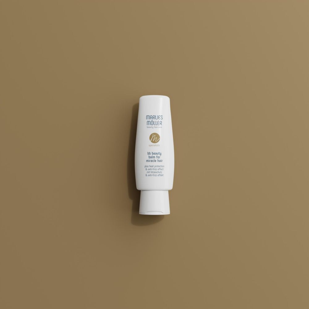 Tube blanc avec impression. Marlies Möller. BB Beauty Balm pour cheveux. Protection thermique. Sur fond marron.