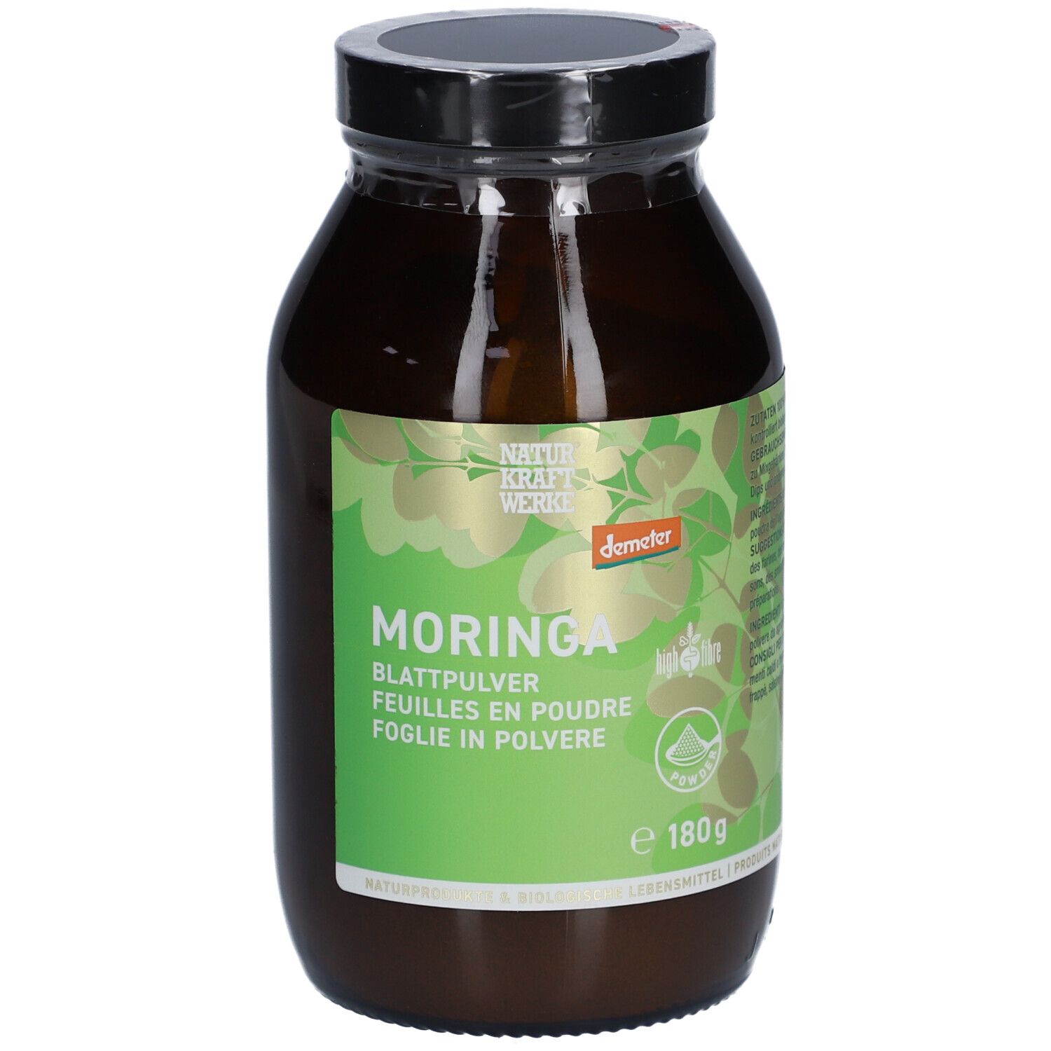 Flacon en verre brun avec couvercle noir. Étiquette verte avec motif de feuilles et texte: Moringa, feuilles en poudre, Demeter, 180g.