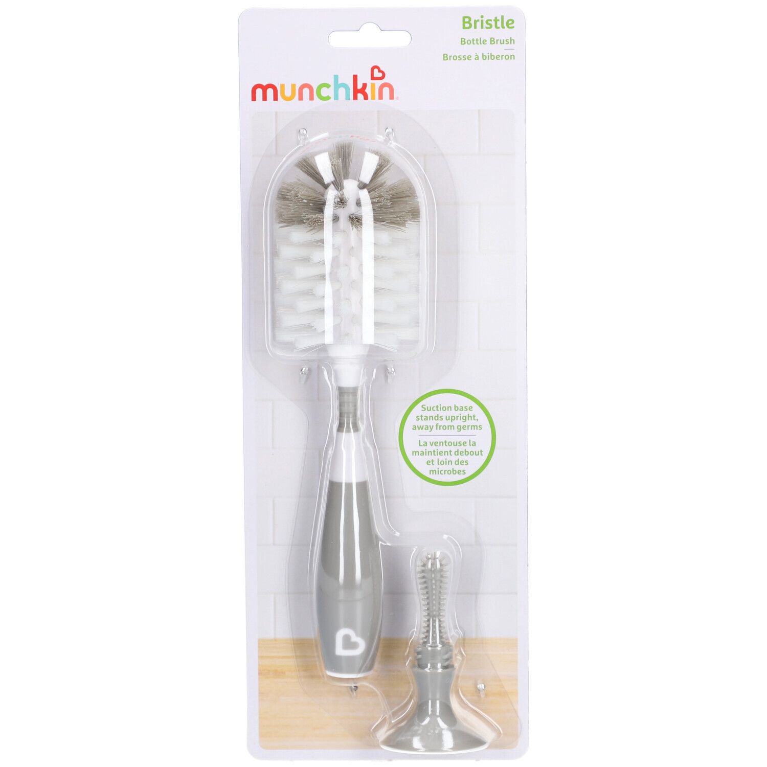 Brosse à biberon avec manche gris et support. Emballage blister avec nom et marque du produit.