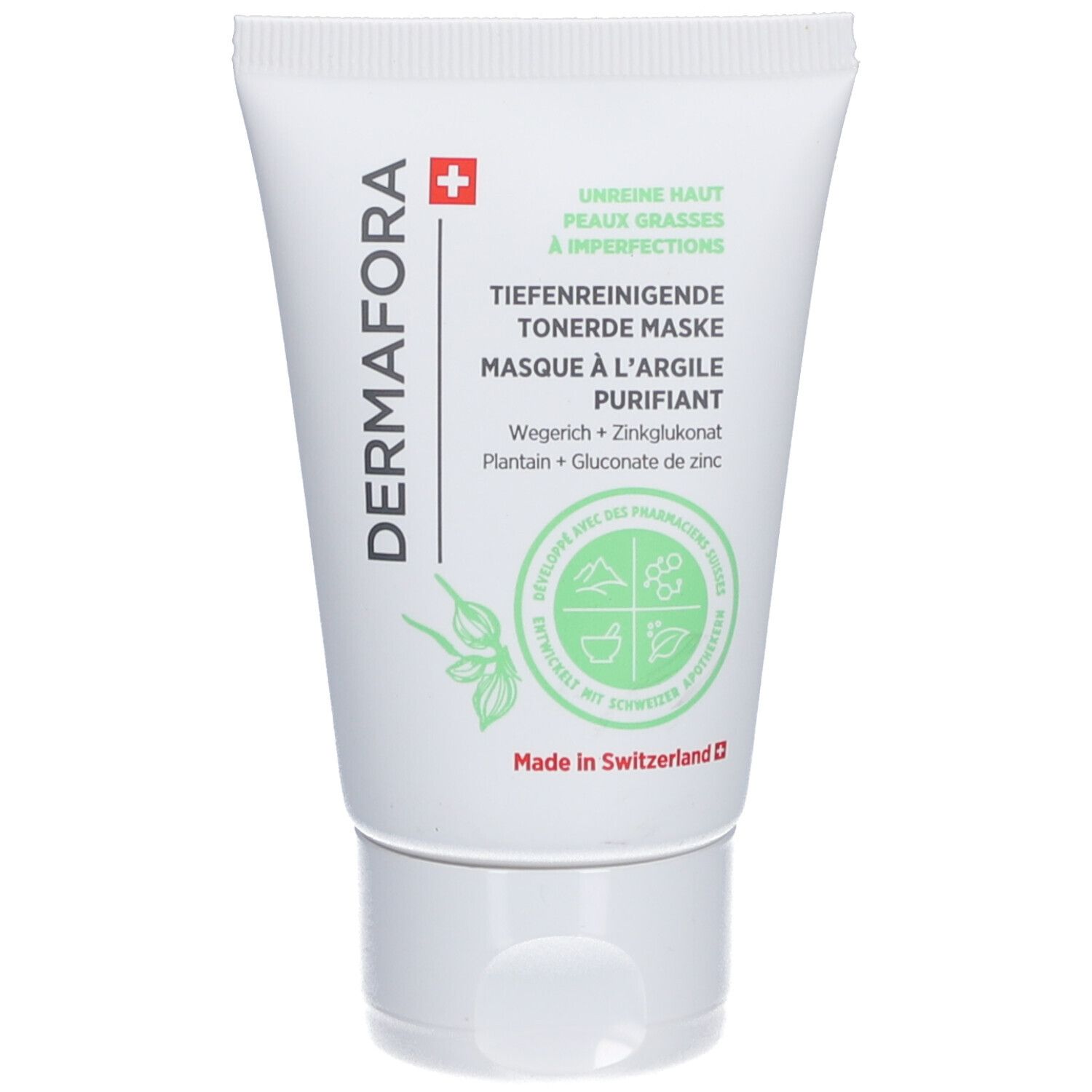 Tube blanc avec impression verte. Texte: DERMAFORA, Masque à l'argile purifiant. Croix suisse. Illustrations végétales.