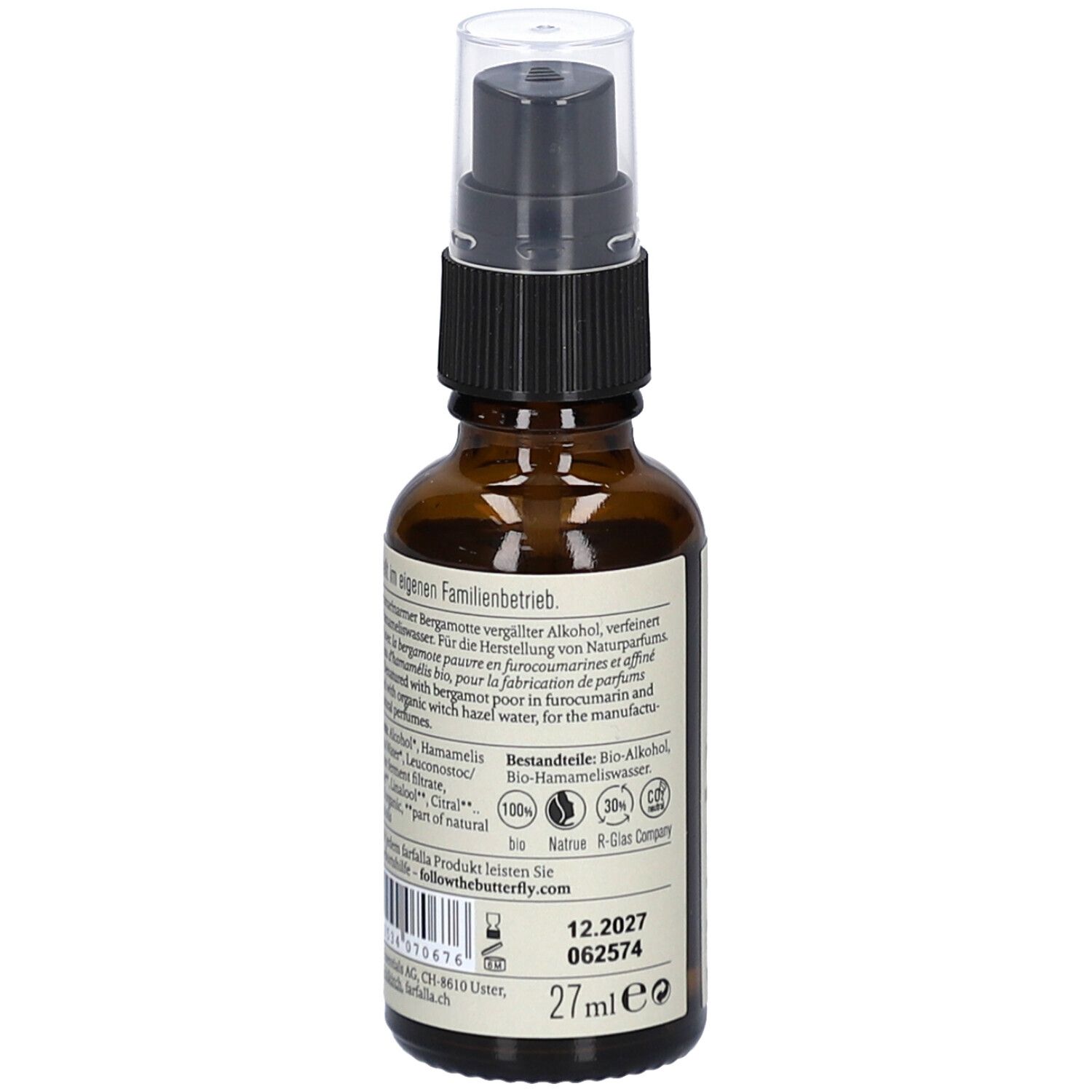 Flacon en verre brun avec vaporisateur. Étiquette avec informations produit, ingrédients et numéro de lot.